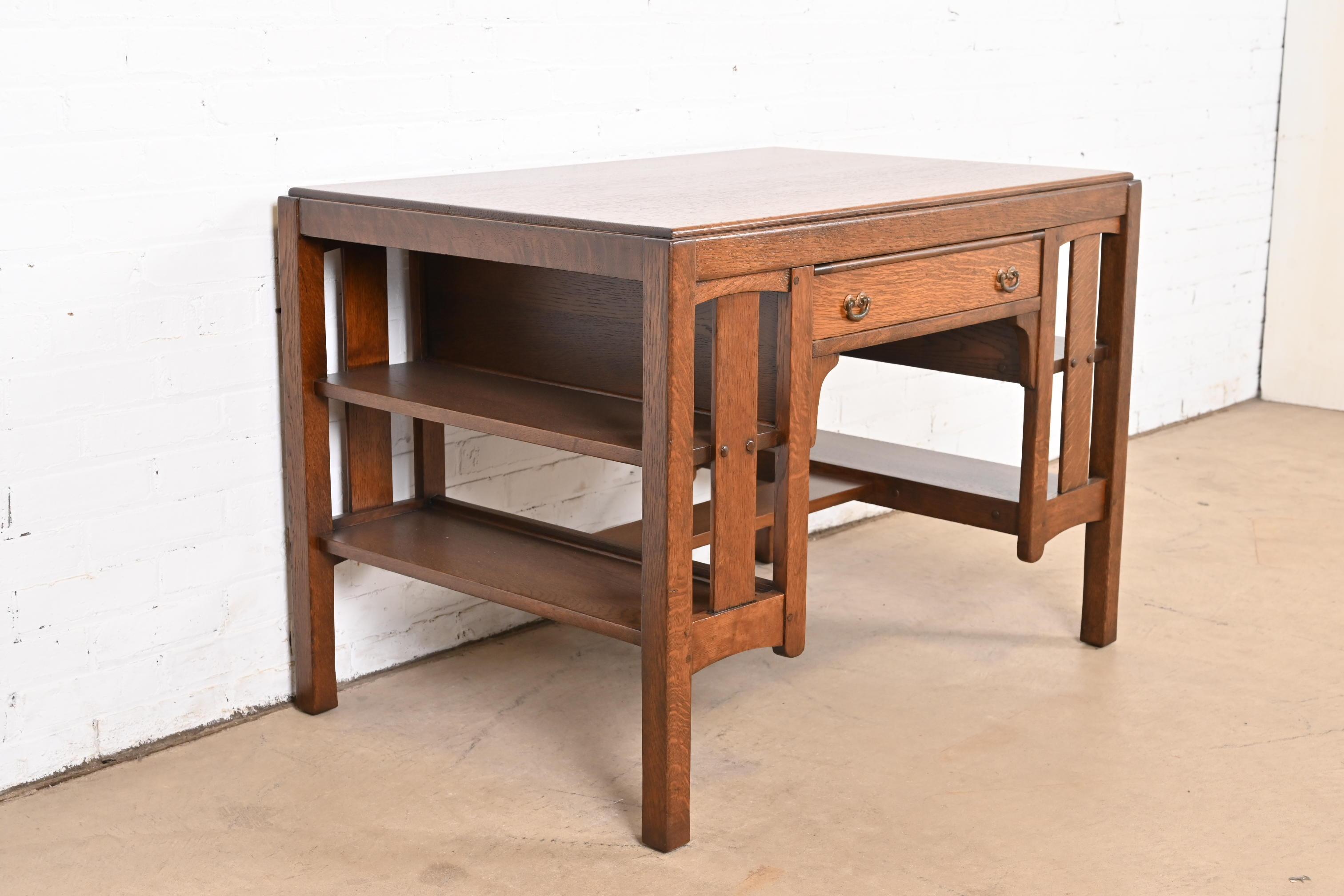 An exceptional Mission or Arts & Crafts library table or writing desk with built-in bookcases

By Charles P. Limbert Co.

USA, Circa 1900

Quartersawn oak, with original hammered copper hardware.

Measures: 41.75