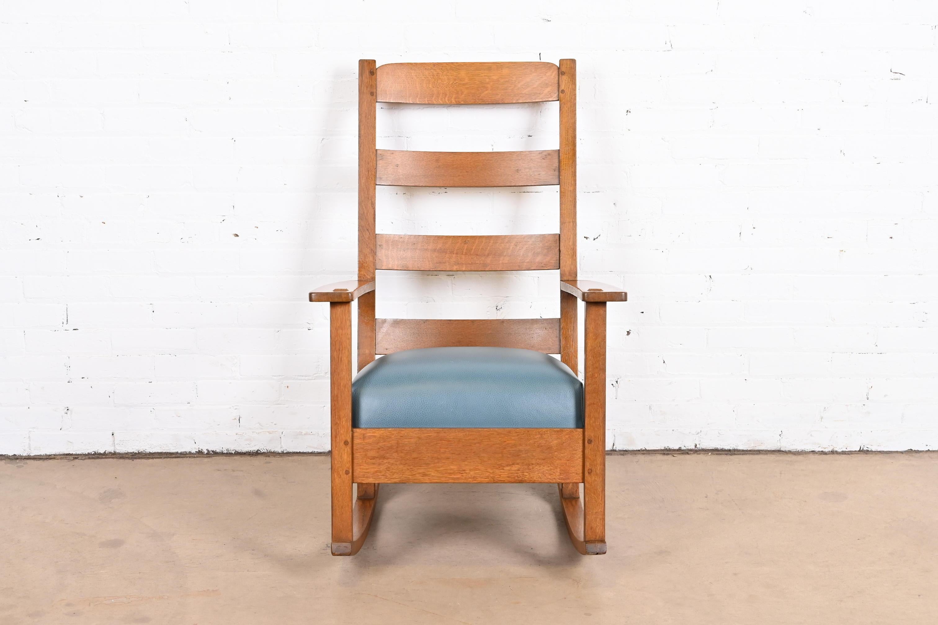 A gorgeous Mission or Arts & Crafts rocking chair

By Charles P. Limbert Co.

USA, circa 1900

Solid quartersawn oak, with newer teal leather upholstered seat.

Measures: 25.75