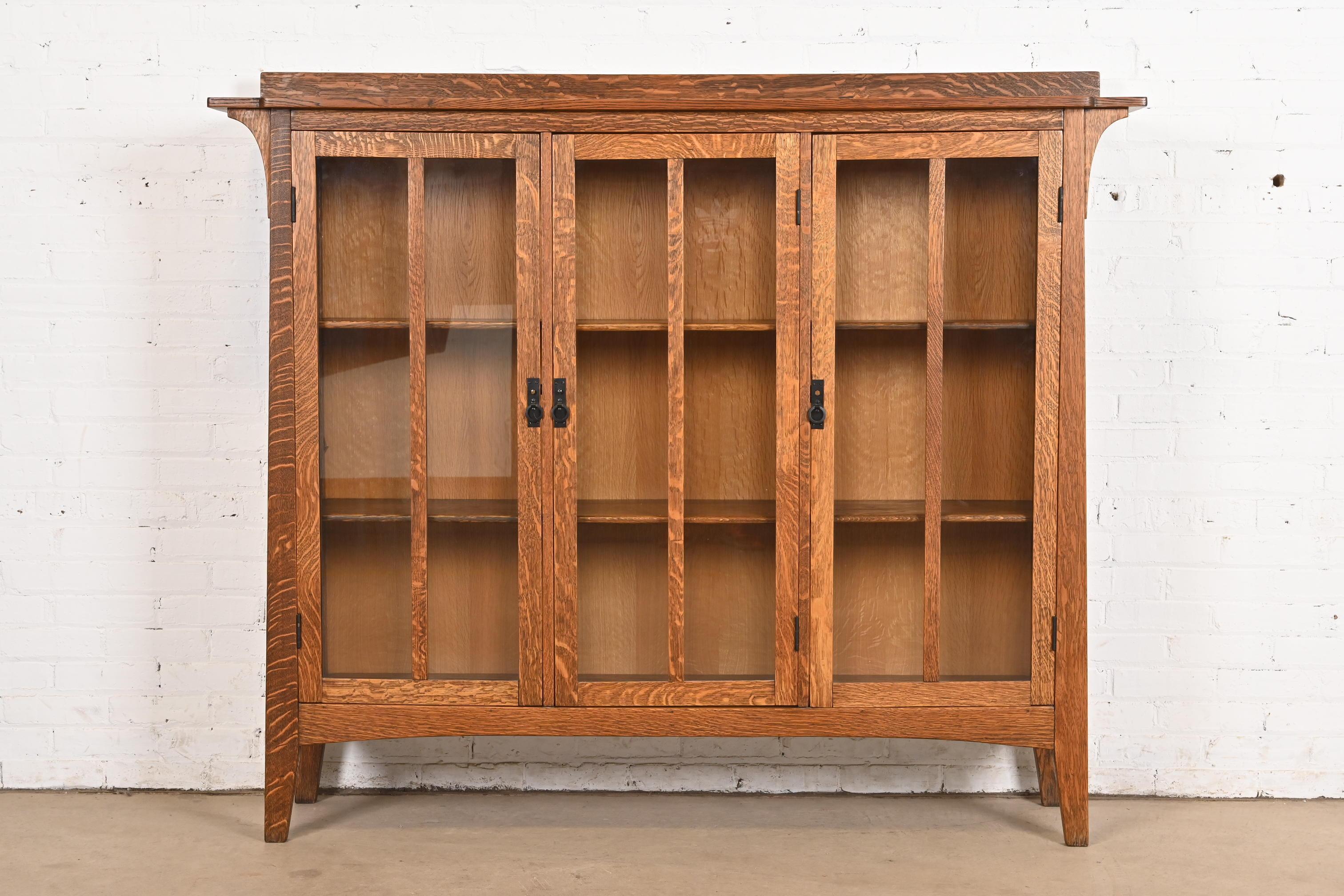 A beautiful Mission or Arts & Crafts triple bookcase cabinet

In the manner of Charles P. Limbert Co.

USA, Circa Late 20th Century

Gorgeous quarter sawn oak, with mullioned glass front doors. Shelves are adjustable.

Measures: 66.5