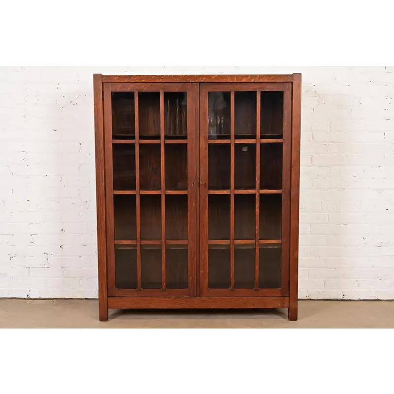 A beautiful Mission or Arts & Crafts period glass front double bookcase cabinet

In the manner of Charles P. Limbert Co.

USA, Circa 1900

Gorgeous quarter sawn oak, with mullioned glass front doors.

Measures: 42.25