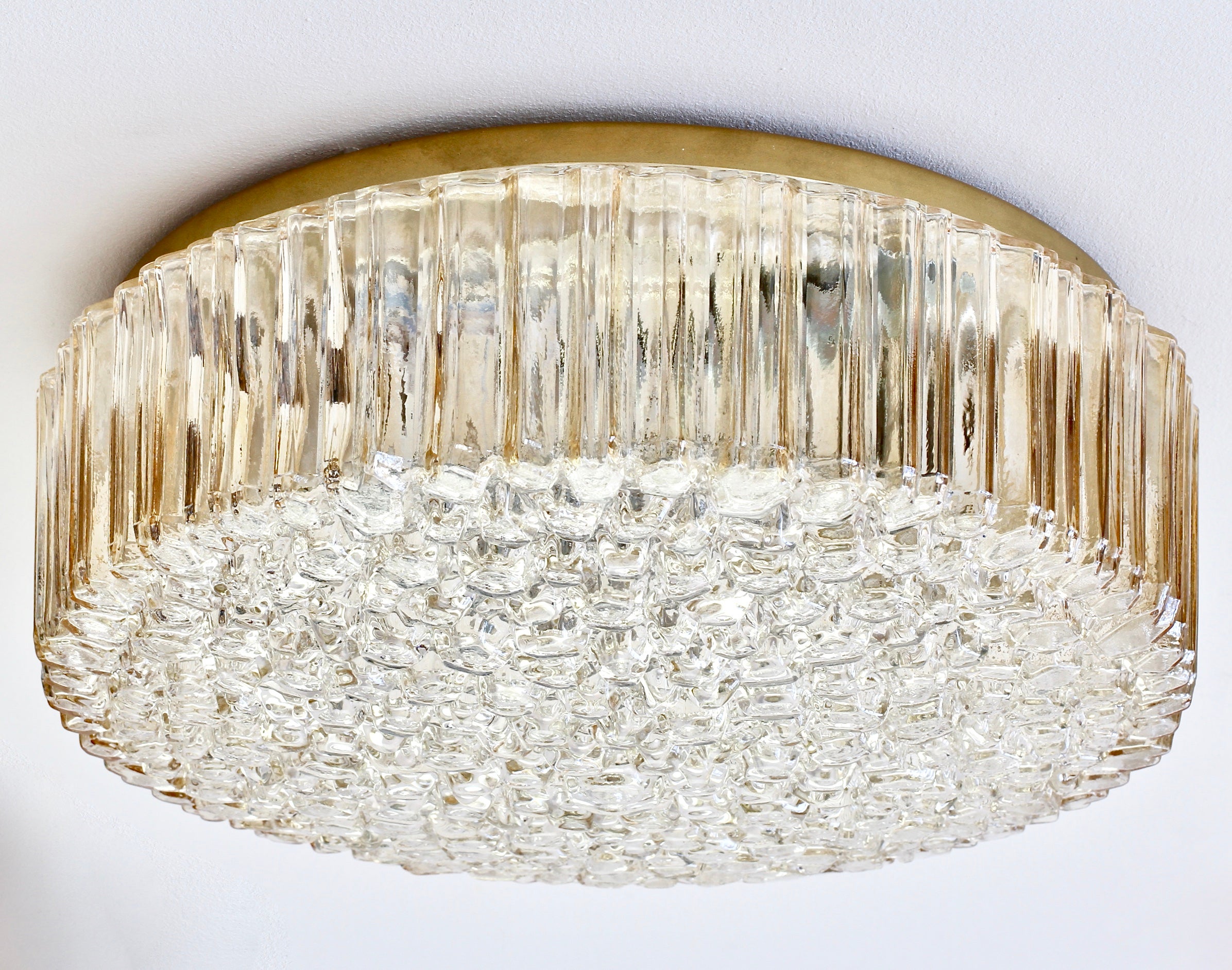 Large 40 cm (16 inch) flushmount light fixture by Glashütte Limburg, circa 1970s. Featuring a wonderful mouth blown, molded and textured champagne colored / amber toned glass shade resembling ice crystals. This Mid-Century vintage lamp illuminates