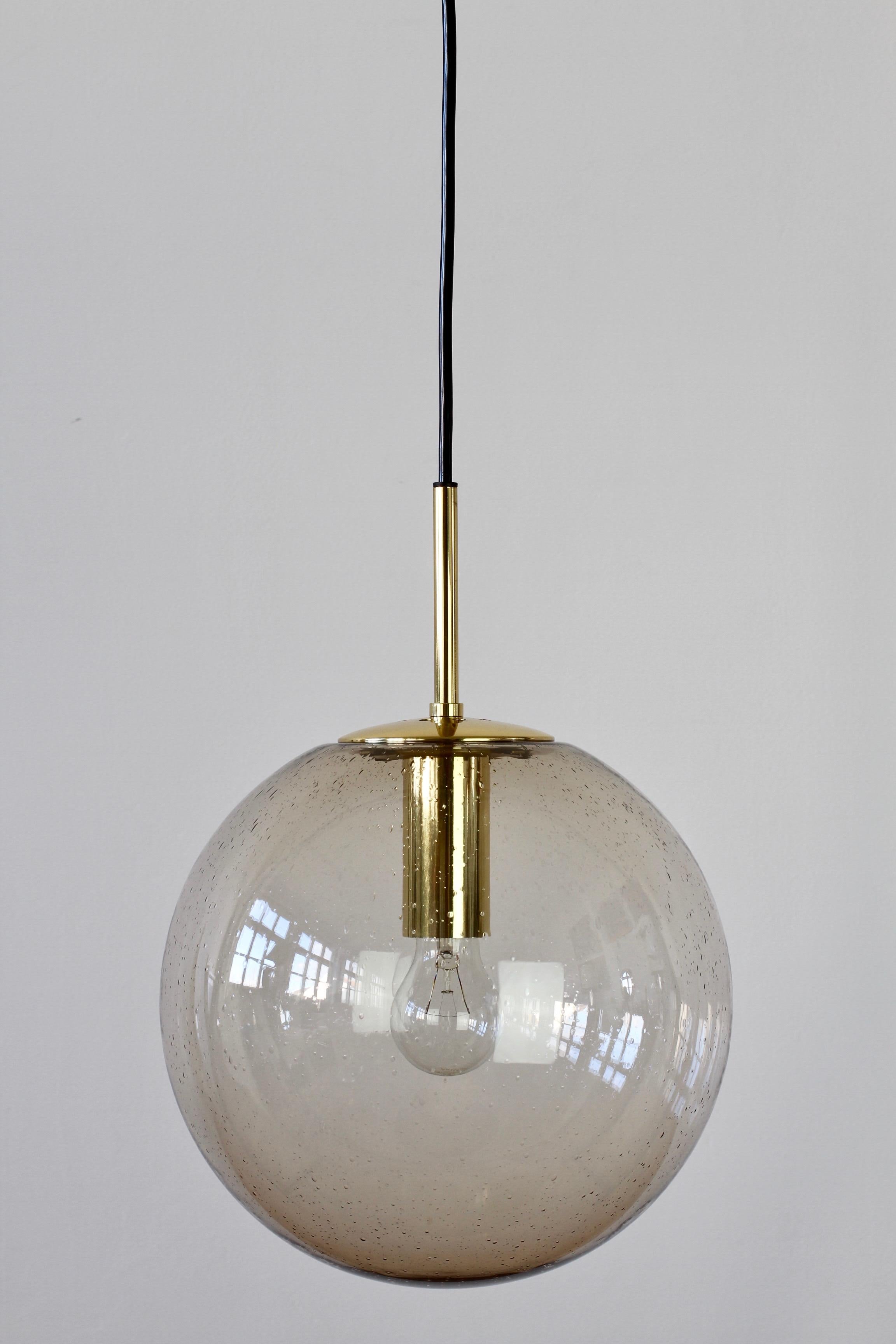 'New old stock' in original box large midcentury hanging pendant lamp / light fixture by Glashütte Limburg. Made in Germany in the late 1960s throughout to the late 1970s, this gorgeous ceiling light features a mouth blown smoked glass globe