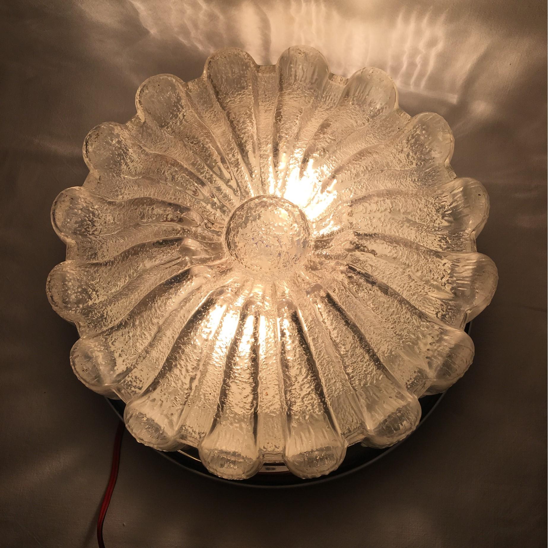 Flush mount in a Flower design from Glasshuette Limburg. Surrounded by chromed metal it emits a beautiful visual and lighting effect. It is equipped with all original 20th century wiring. It requires two E 26 / 27 Edison bulbs for maximum lighting