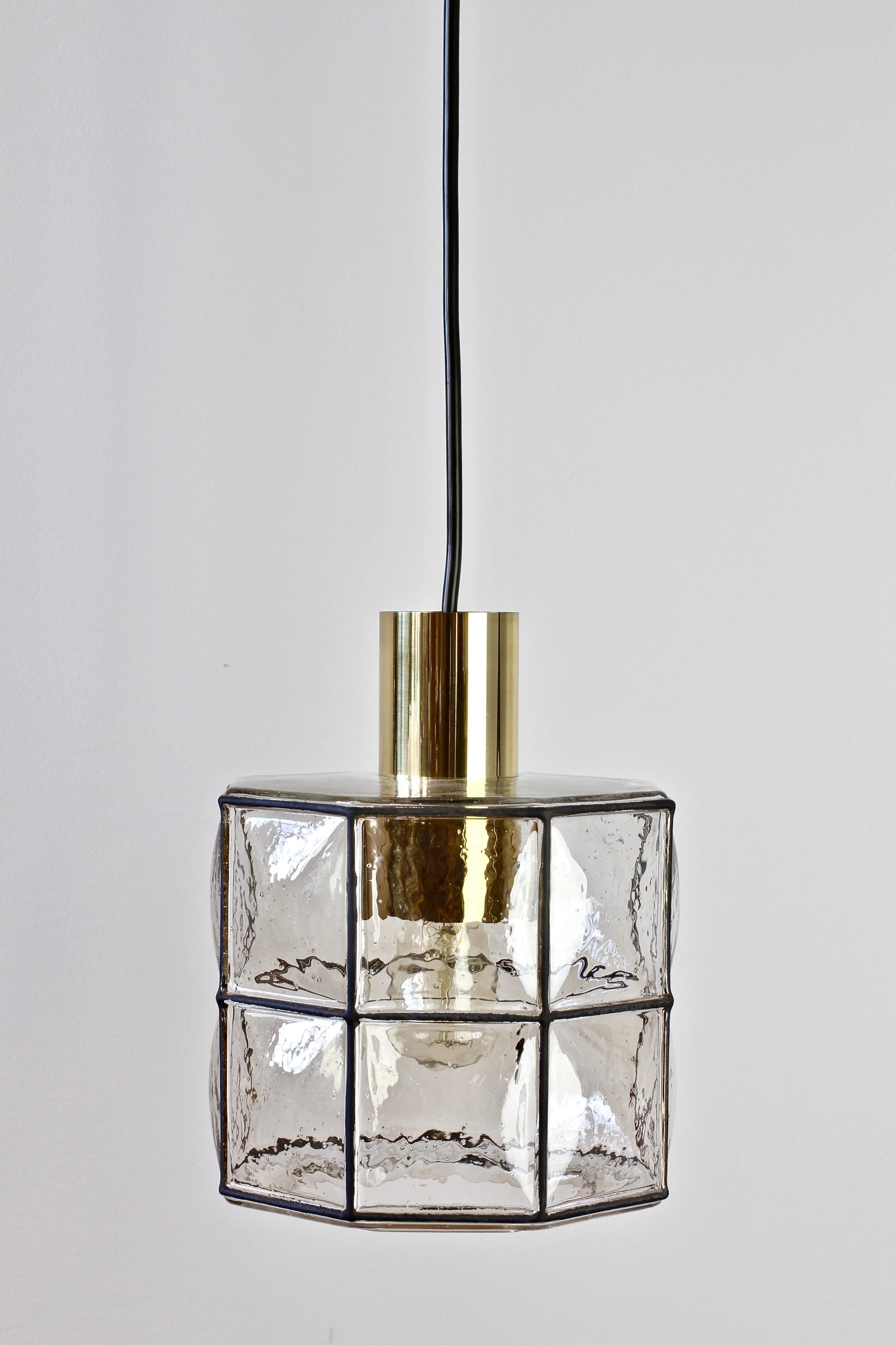 Limburg Glashutte (new old stock) minimal, geometric and simply shaped pendant lamp or light fixture made in Germany, circa 1965. The Pulegoso or 'bubble' glass bulges slightly out of the black 