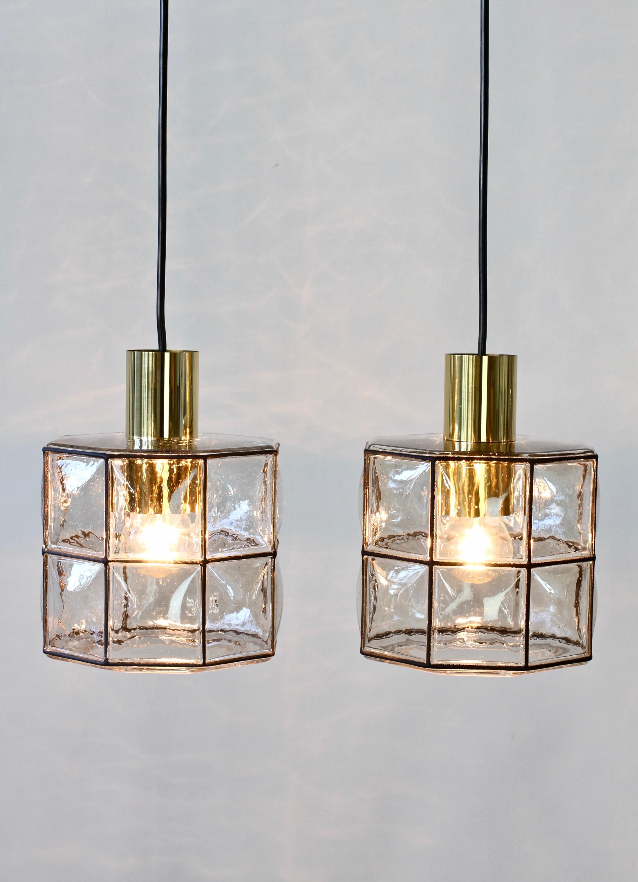 Limburg Glashutte minimal, geometric and simply shaped pendant lamp or light fixtures made in Germany, circa 1965. The Pulegoso or 'bubble' glass bulges slightly out of the black 