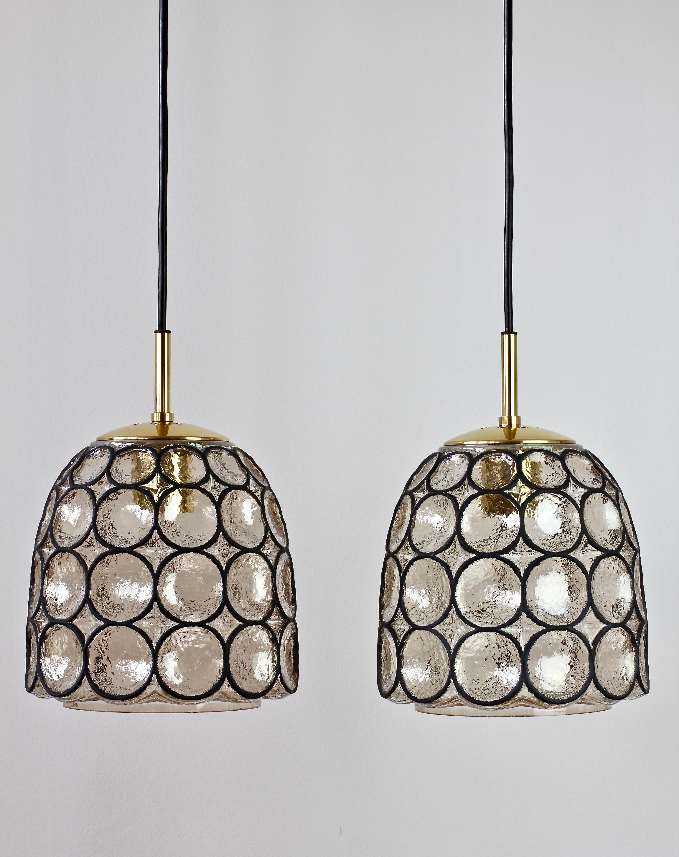 Par of Limburg Glashutte vintage Mid-Century Modern minimal, geometric and bell shaped pendant ceiling lamp or light fixtures made in Germany, circa 1965. The Pulegoso or 'bubble' glass bulges slightly out of the black 