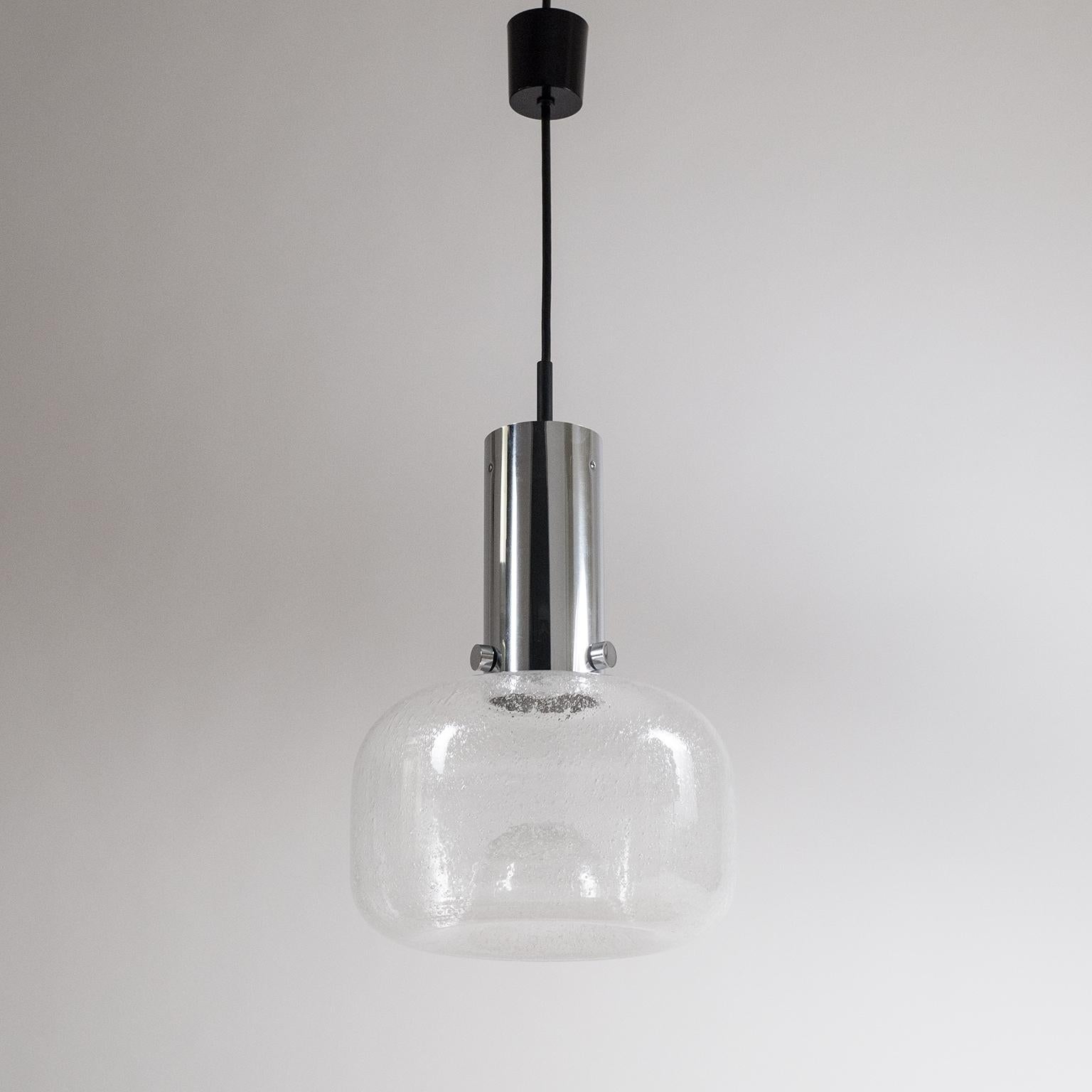 Excellent Space Age pendant by Limburg, Germany, 1970s. The beautifully shaped blown clear glass body contains countless small air bubbles for a spectacular light effect. The E27 socket is recessed far into the chrome tube so that the light source