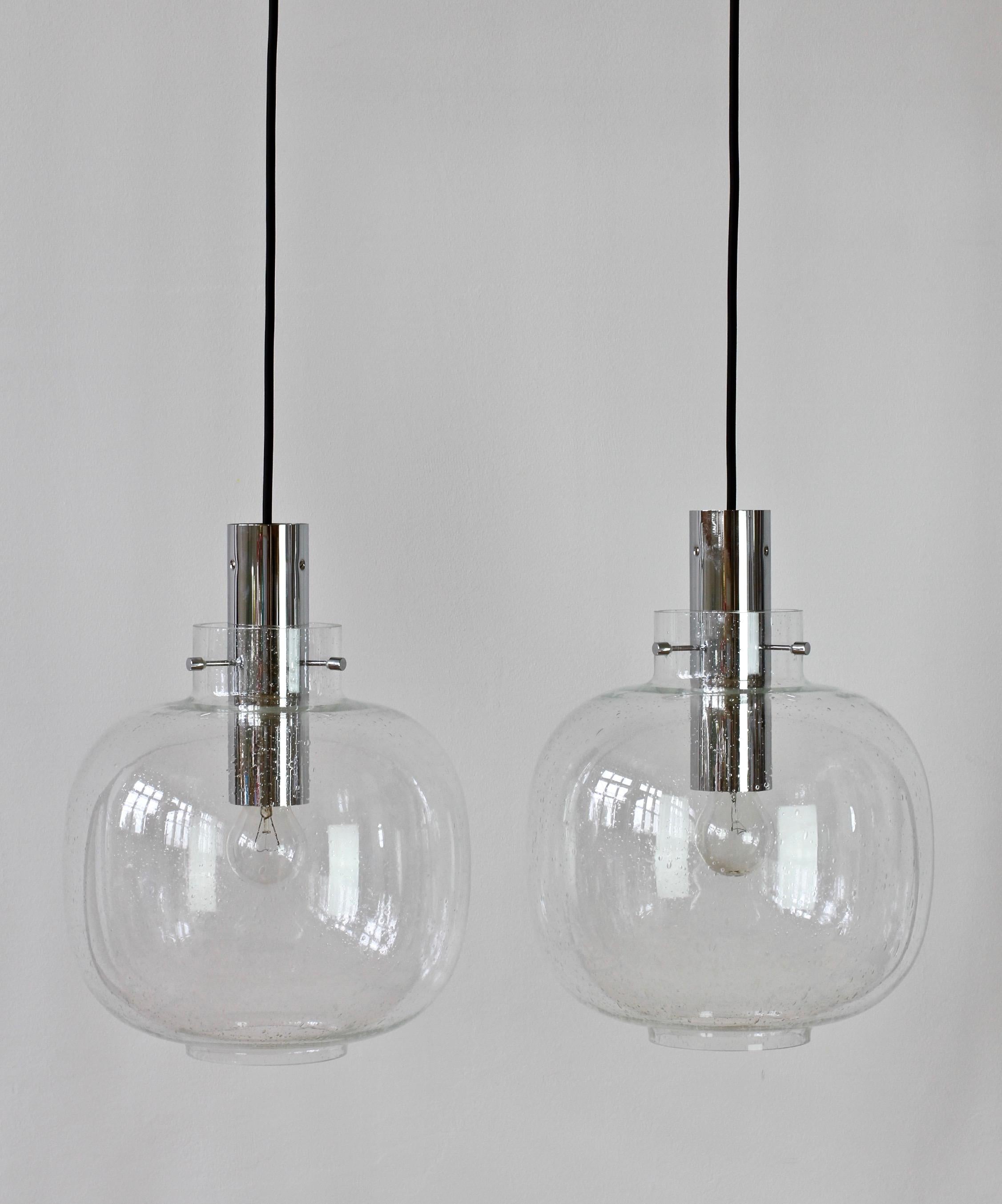Large vintage pair of German made late Mid-Century Modern wall or ceiling flush mount lights produced by Glashütte Limburg, circa 1975. Featuring a round domed mouth blown bubble glass shade and polished chrome mounts or hardware. Being mouth blown