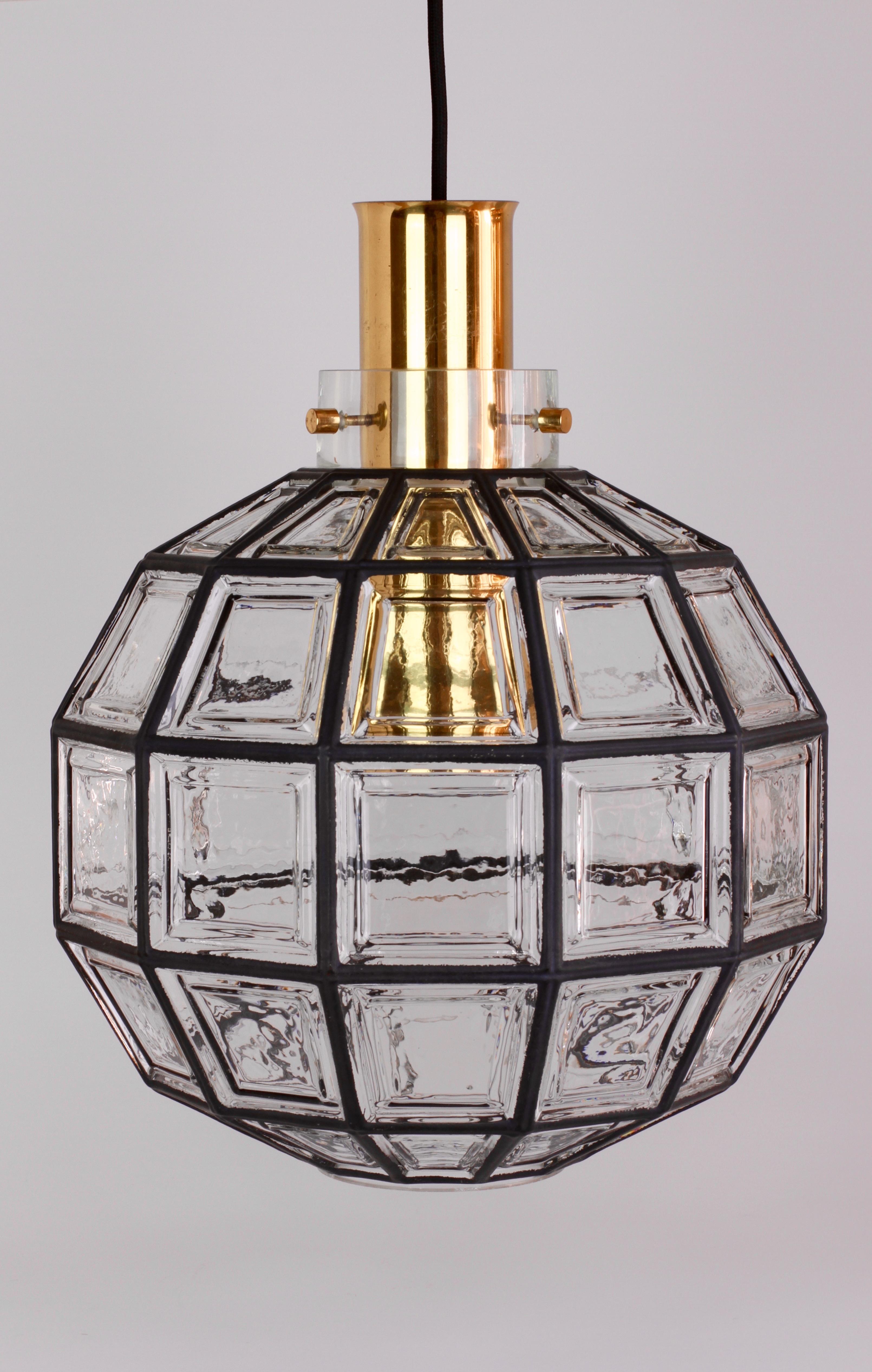 One of a set of three refurbished, beautifully designed and crafted, octagonally shaped and multi-faceted clear glass and brass midcentury pendant lights. These large minimalistic, Contemporary Art Deco lantern style lights were manufactured by