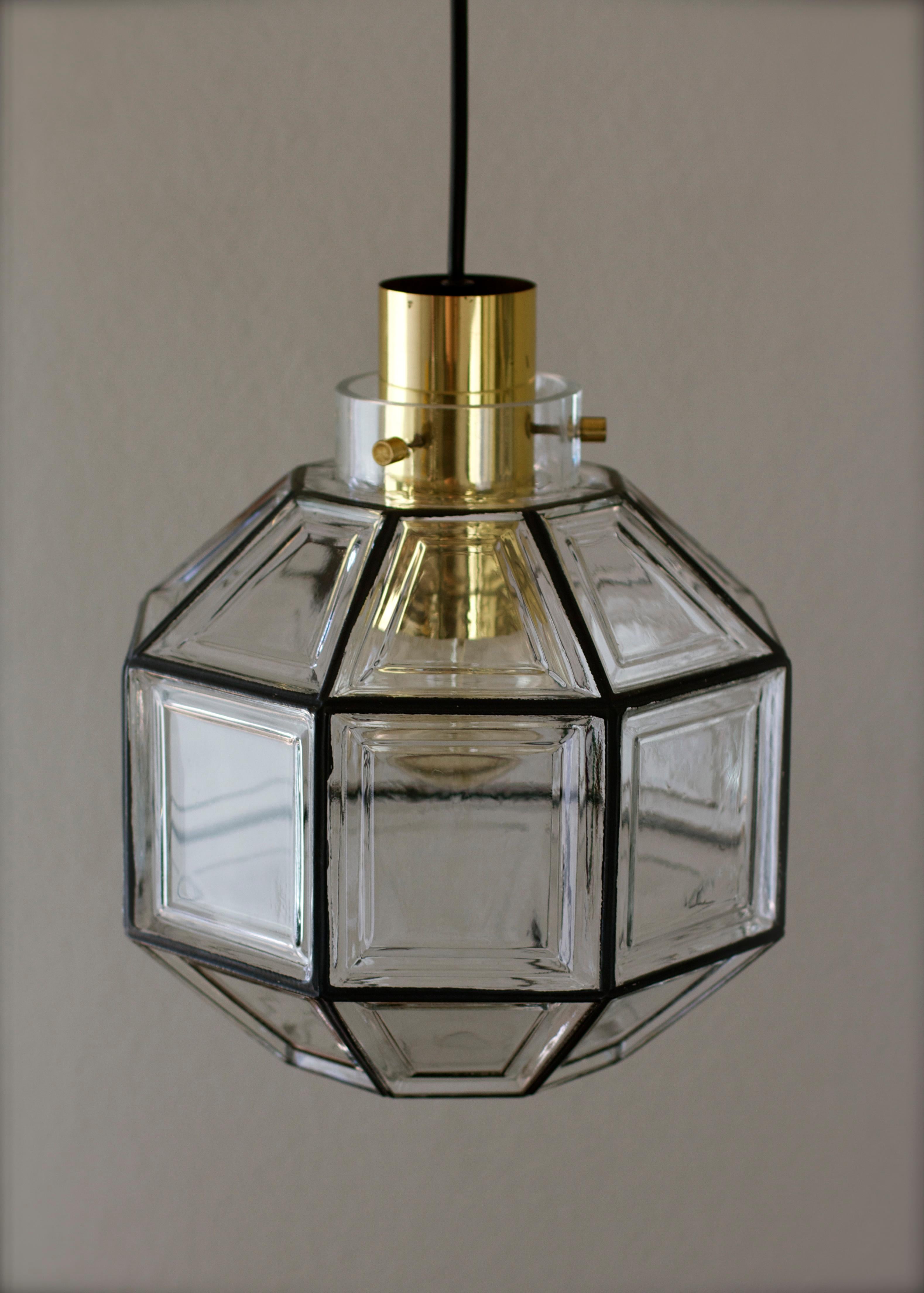 Pair of beautifully designed and crafted octagonally shaped and multi-faceted clear glass & polished brass Mid-Century Modern pendant lights. These minimalistic, Contemporary Art Deco, Lantern style lights or hanging ceiling lamps were designed by