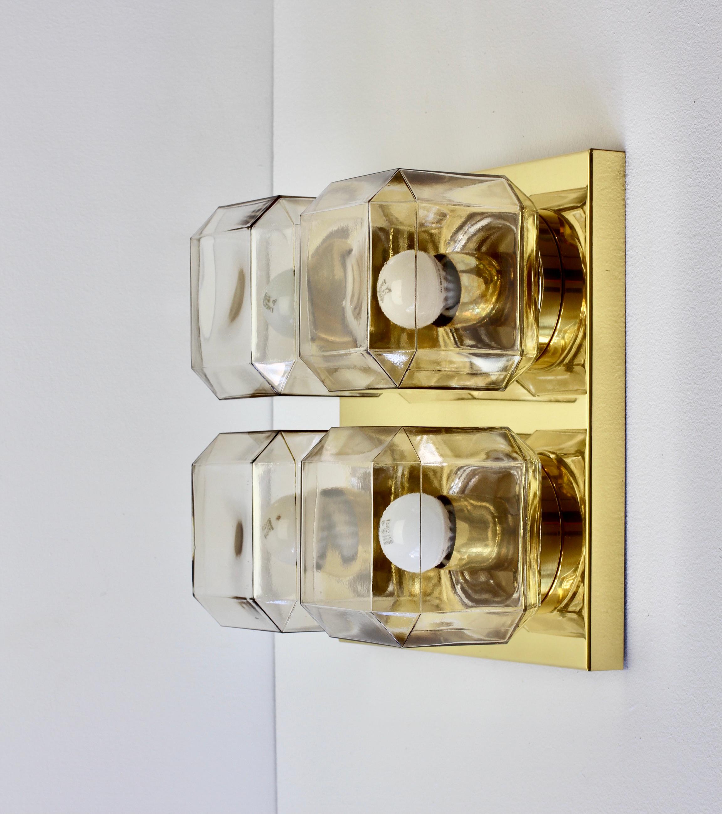 One of two pairs of large vintage Industrial style ceiling flush mount light by Glashütte Limburg, circa 1975-1985. Featuring 4 square geometric shaped mouth blown glass elements with a champagne tone & mounted on a polished brass base or mount.