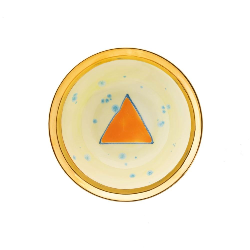 The Gold Impressions collection takes Coralla's exploration of geometry and minimalism to a new dimension, infusing her iconic designs with radiant gold accents. These golden elements transform familiar symbols, like the Mountain, into luminous