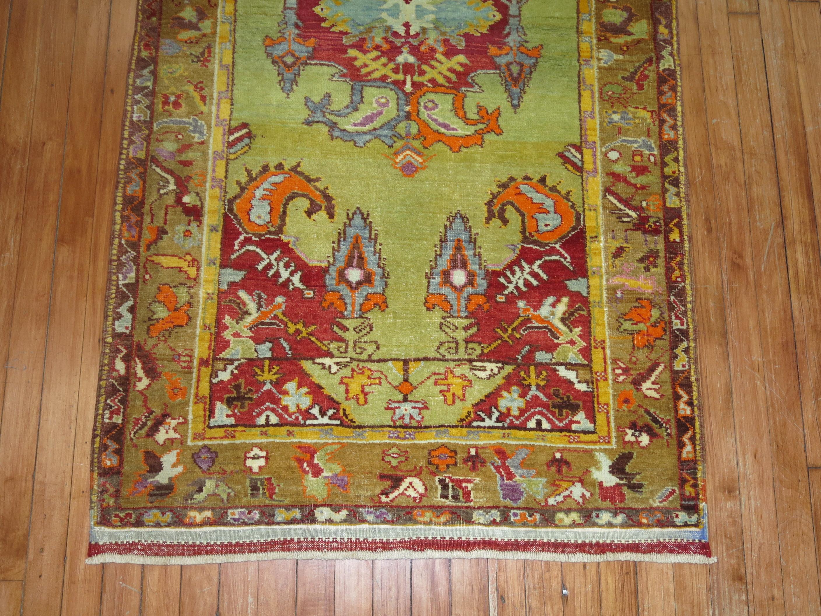 A fascinating mid-20th century Persian runner with an open lime green field. Accents in pumpkin, yellow, brown and red. All the colors are original which is quite remarkable. A statement piece.

Measures: 3'2