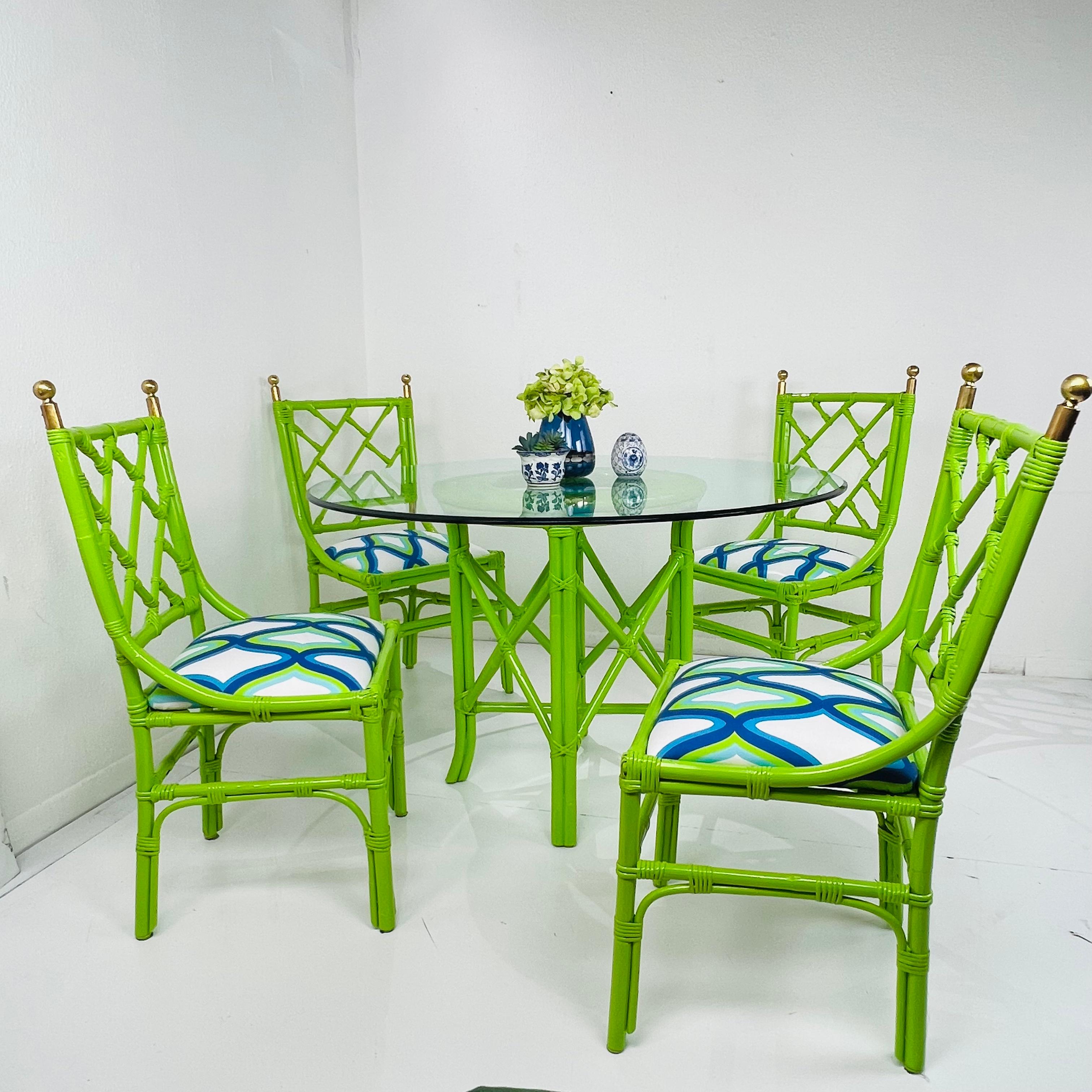 Add a bold pop of color to your summer with this lime green patio set! Includes 4 Chinese chippendale style chairs with newly upholstered seats and brass finials, and round faux bamboo table base with glass top. Good structural condition with some