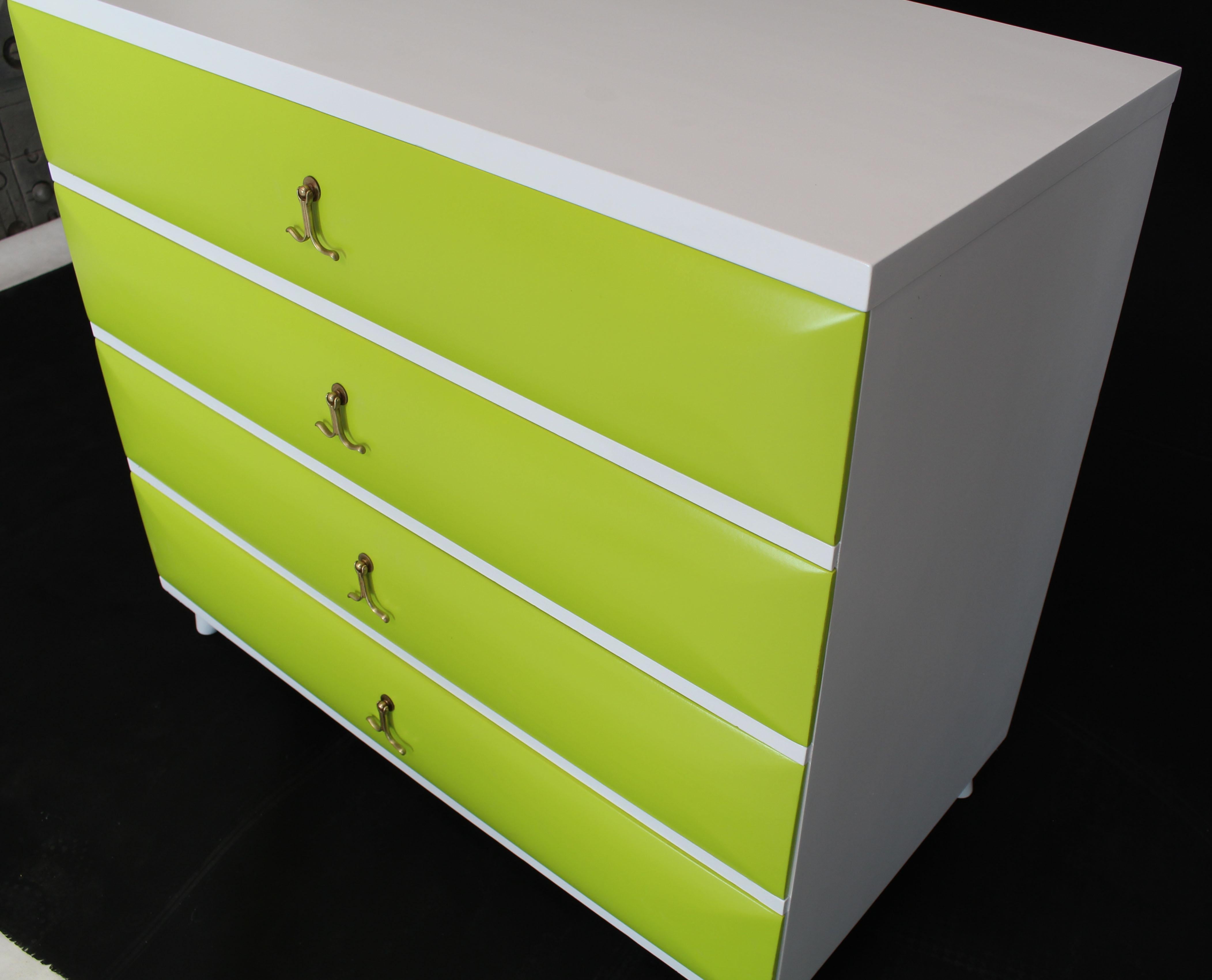 Brass pulls solid mahogany diamond front drawers Mid-Century Modern bachelor dresser chest on horn shape legs. Two-tone lime green white lacquer finish.
 