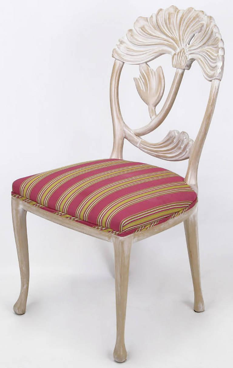 An inspired rendition of a traditional form, this Italian made side chair has a large floral carving within an oval back, slight cabriole, legs and a striped silk upholstered seat. Attributed to Phyllis Morris as we have a set of identical arm