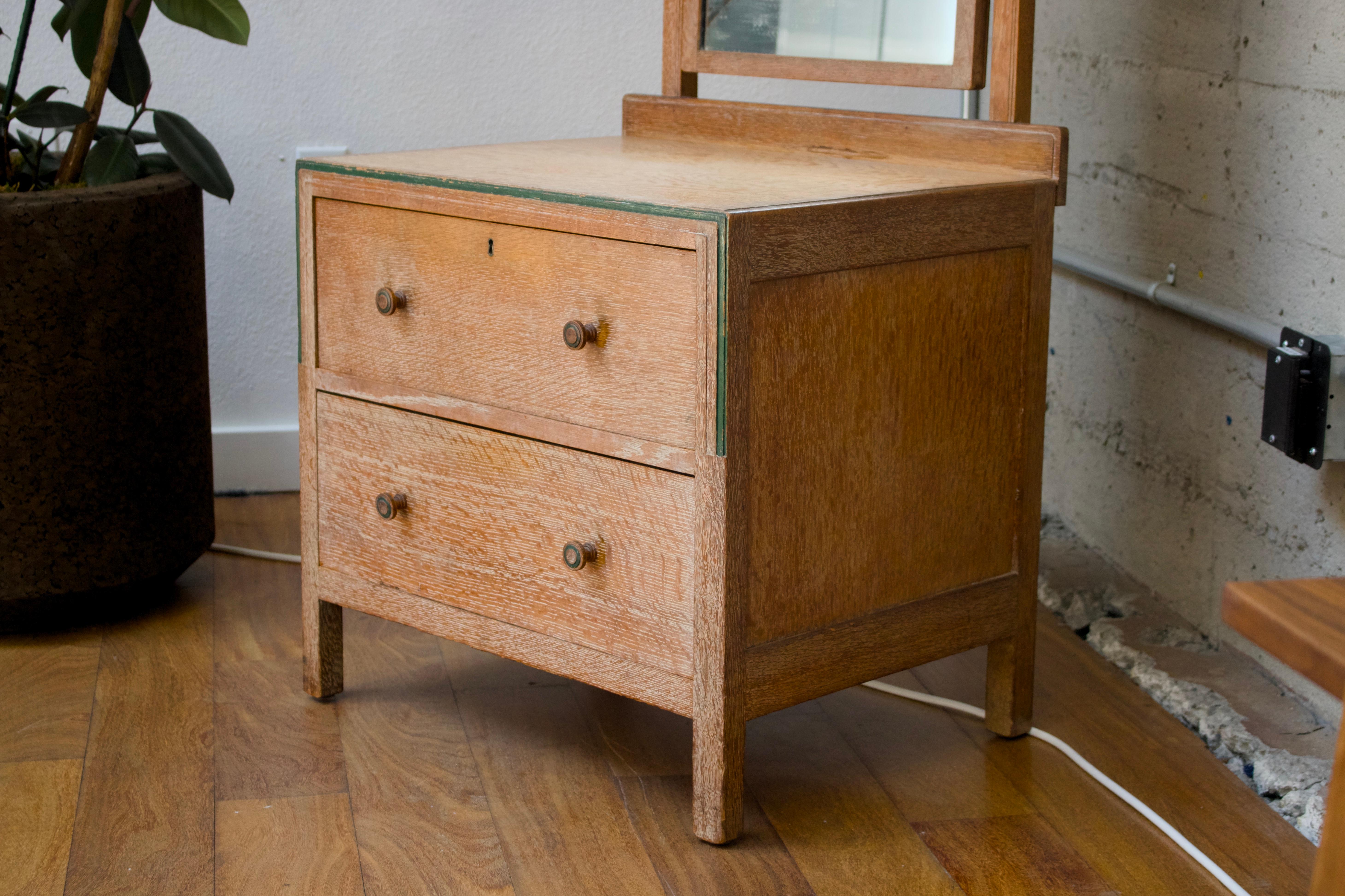 English Limed oak chest with drawers, mirror by Heals of London For Sale