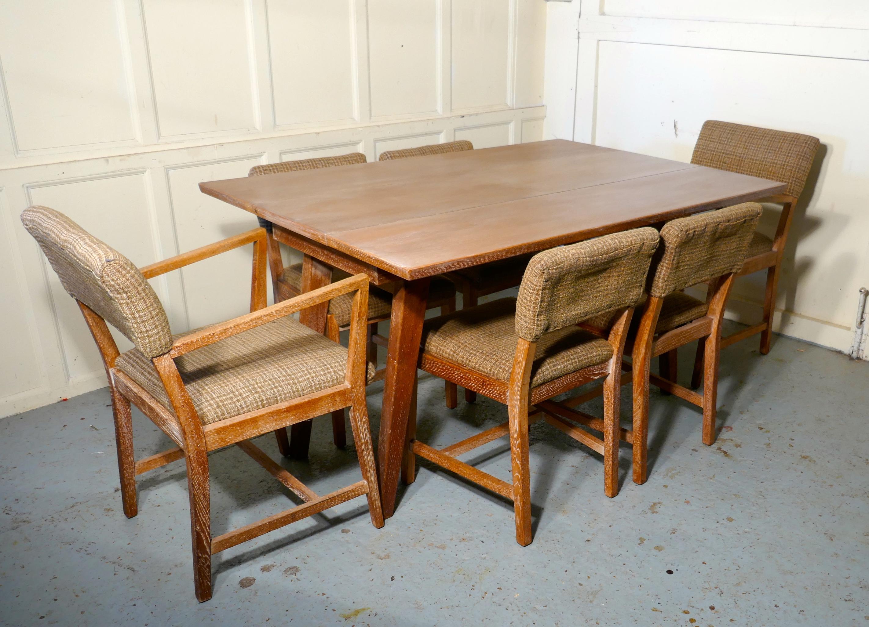 Limed Oak Extending Dining Table and set of 6 Chairs

A very rare set, the splay legged table pulls apart in the centre allowing a centre leaf to pop up making a small narrow table into large 6 seater dining table
The set is in limed oak, it is in