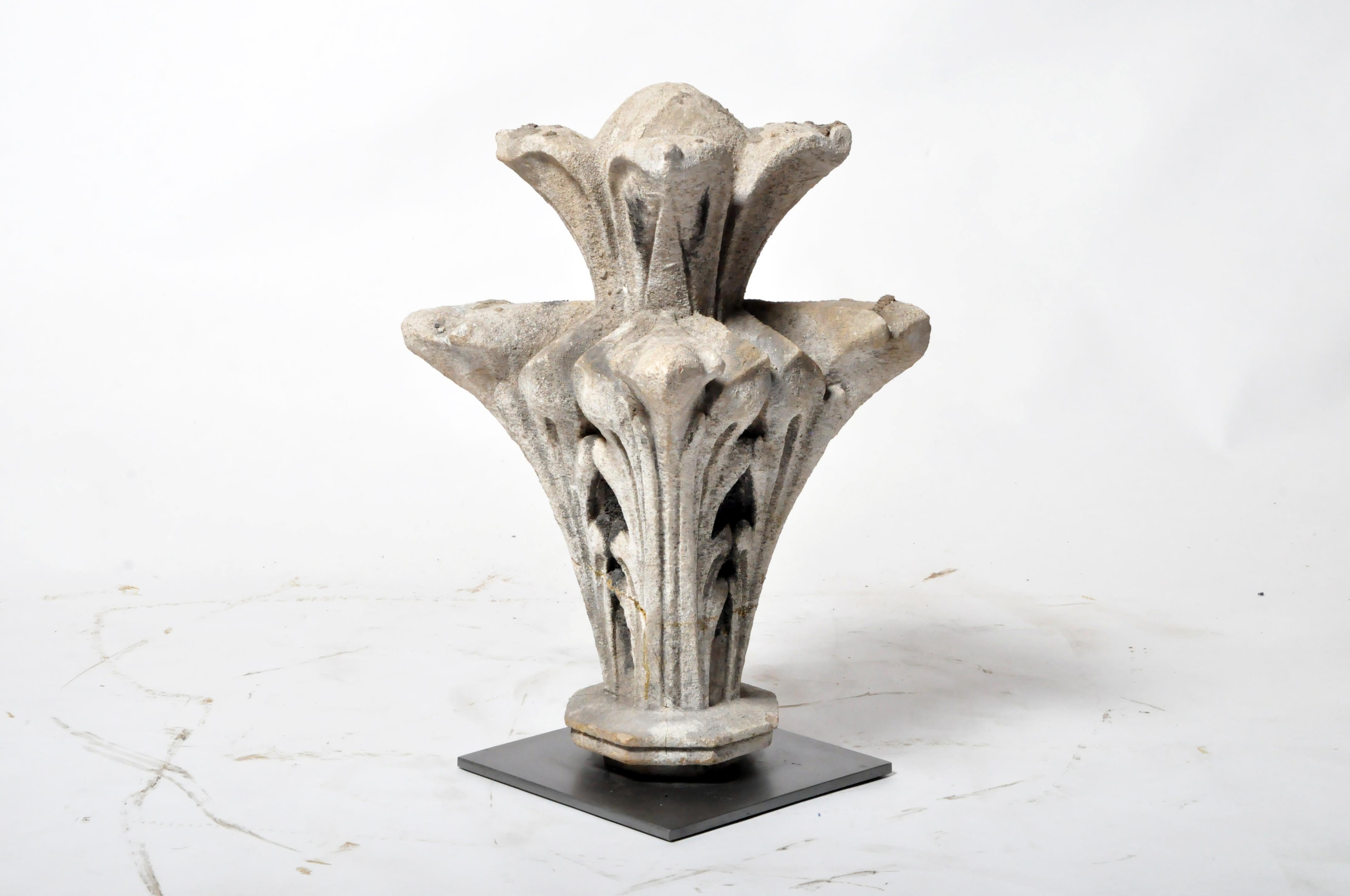 This carved limestone floral decoration once crowned the parapet of a French chateau. It dates to the early 19th century. Wear consistent with age and use.
 