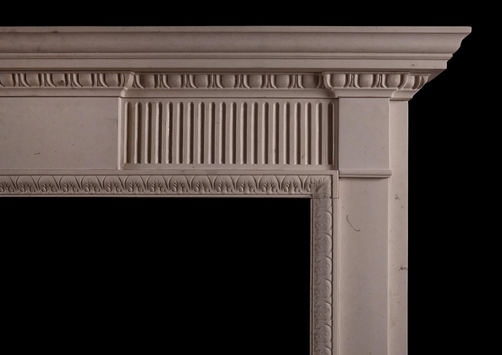 An elegant neoclassical style limestone fireplace, reflecting the designs of the late 18th century. The fluted frieze with plain centre and side blockings. The inner moulding of carved waterleaf, and the moulded shelf with egg and dart bed moulding.