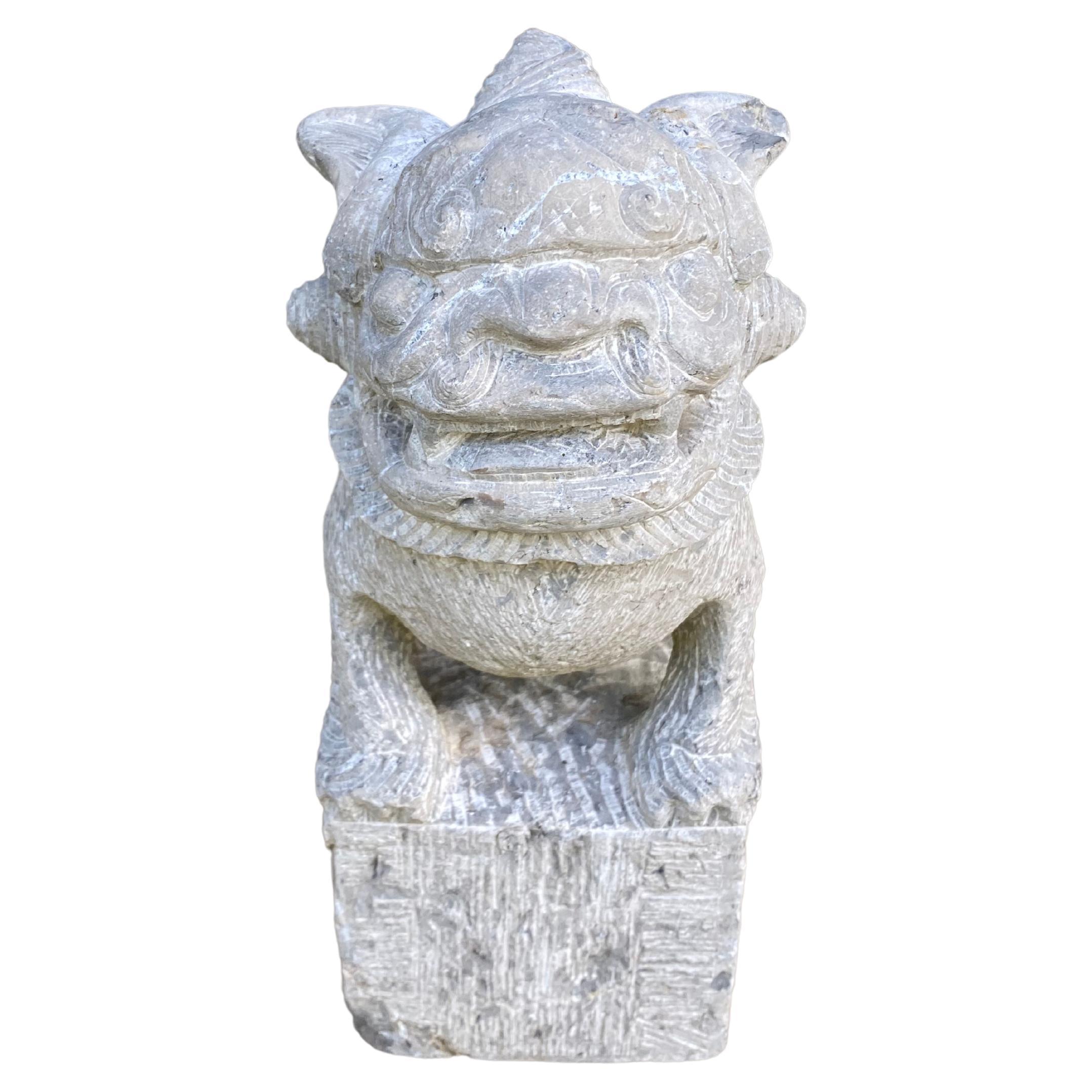 This limestone carving depicts a Fu Dog Guardian figure and was carved from a solid block. Sculptures such as these were used to protect ones home from bad spirits or bad luck. They were often placed in the garden or entrance. There are carved