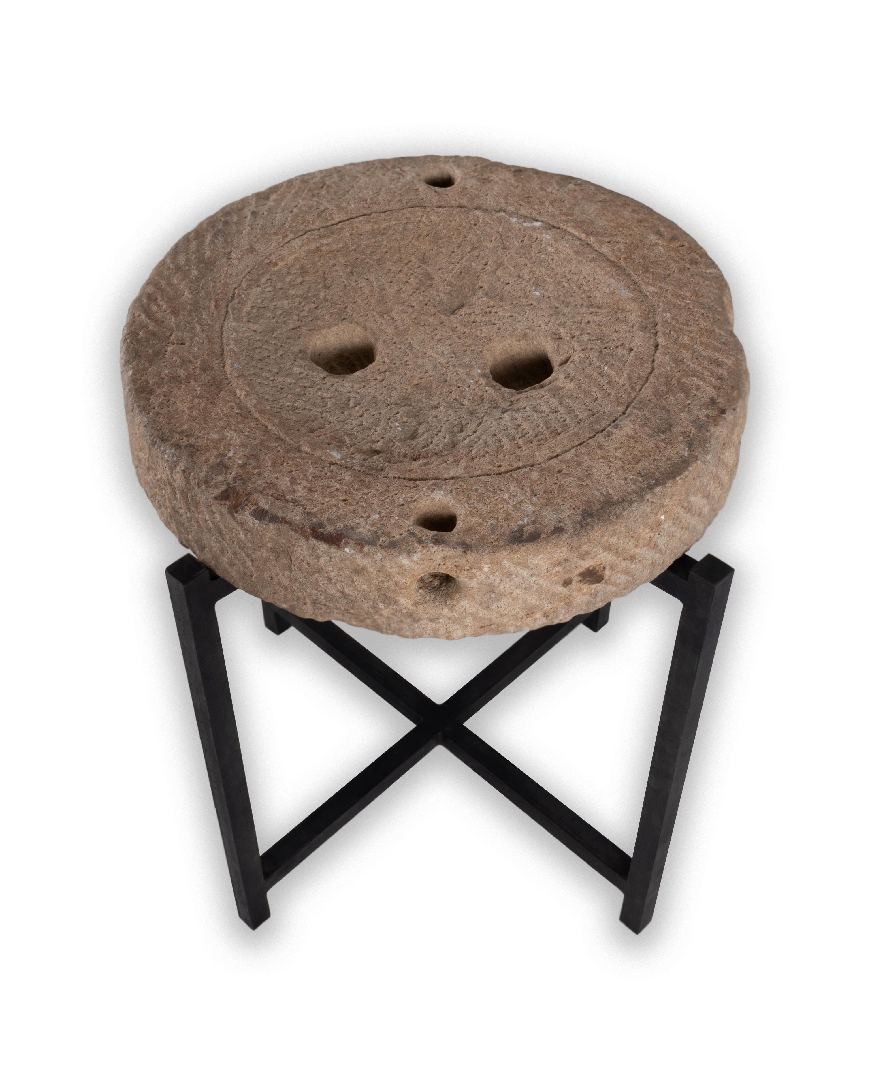 Limestone Mill wheel on stand.

This piece is a part of Brendan Bass’s one-of-a-kind collection, Le Monde. French for “The World”, the Le Monde collection is made up of rare and hard to find pieces curated by Brendan from estate sales, brocantes,
