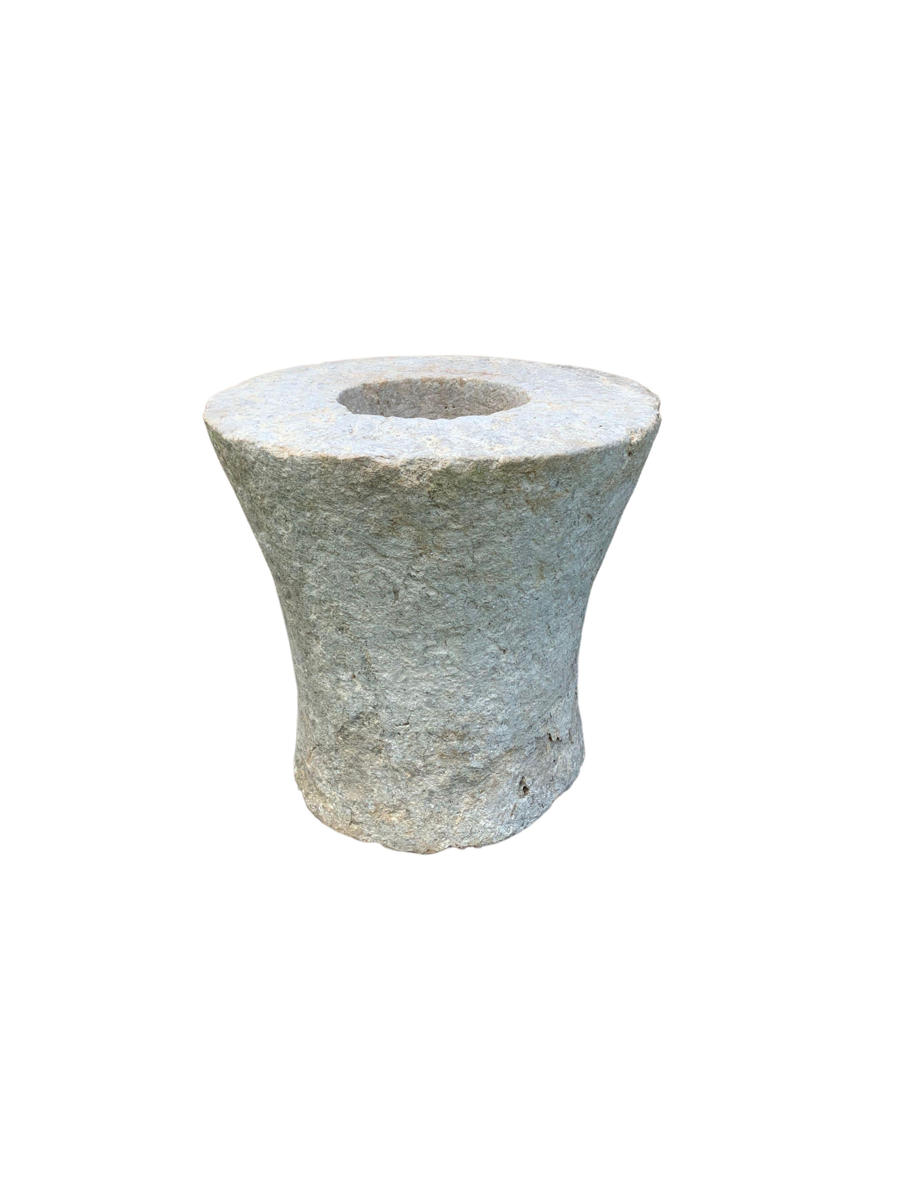 A limestone mortar soured from rural Java & crafted from a solid limestone slab. A raw and organic object with beautiful textures. A versatile decorative object despite its once utilitarian function of pounding spice mixes. It has a great weight to
