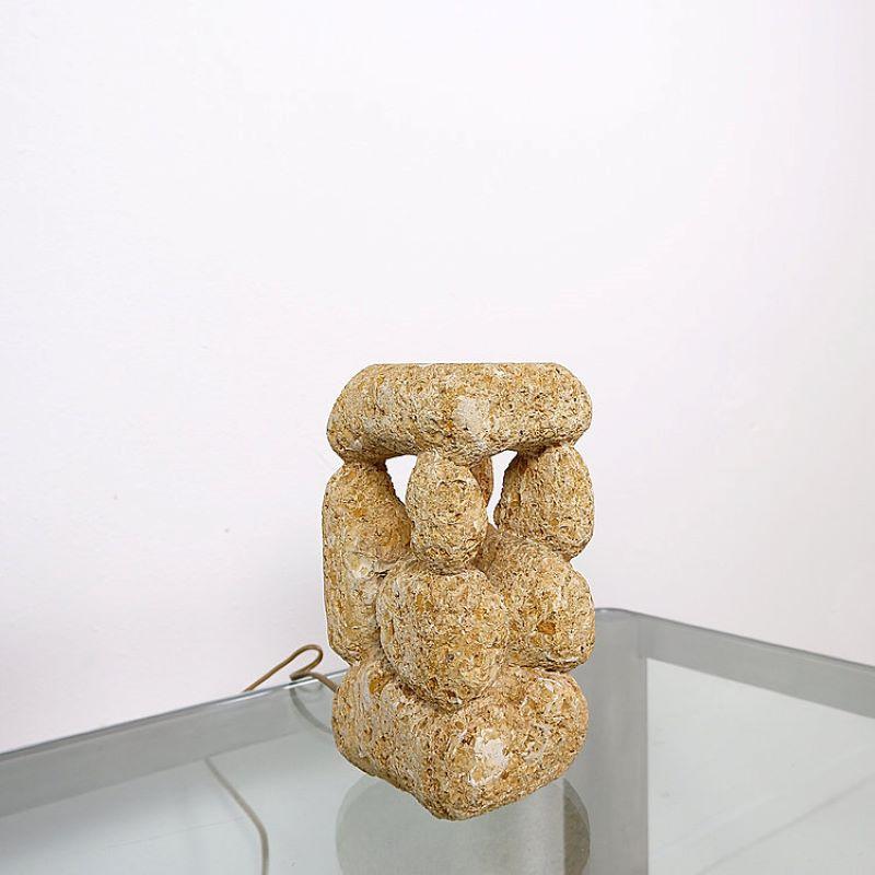 Table lamp covered in limestone.