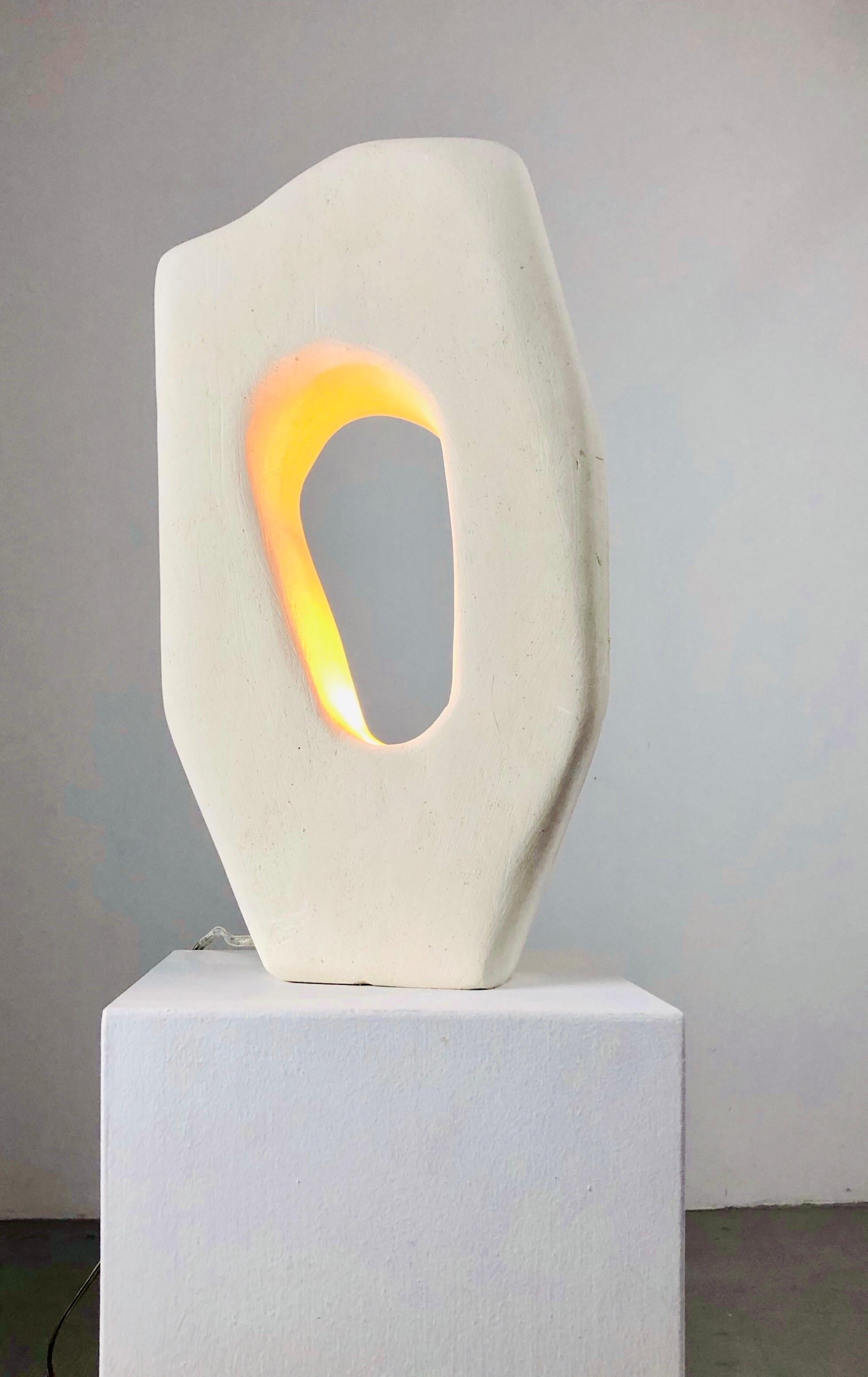 A 2010s solid carved limestone lamp, France by Michel Bonhomme, French artist.

Stunning shape, Lightbulb is hidden in the bottom of the stone.

Fully rewired, with lightbulb E14 and switch