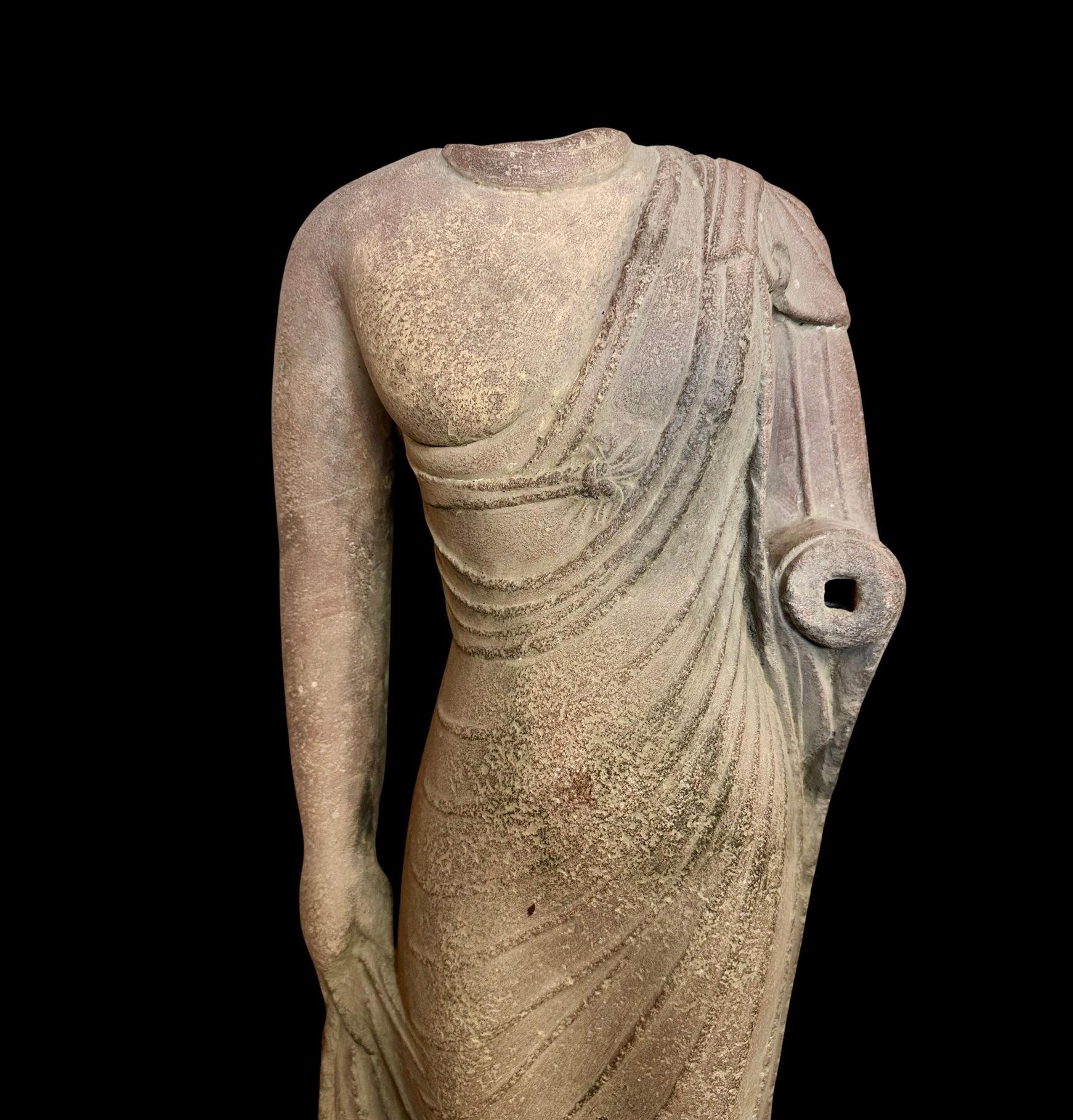Magnificent Limestone Torso of Buddha
With arms slightly angled, the figure is wearing a long robe falling in loose elegant pleats over the torso, with the left arm raised, and the other gently holding the robe at the side. Loss and damage