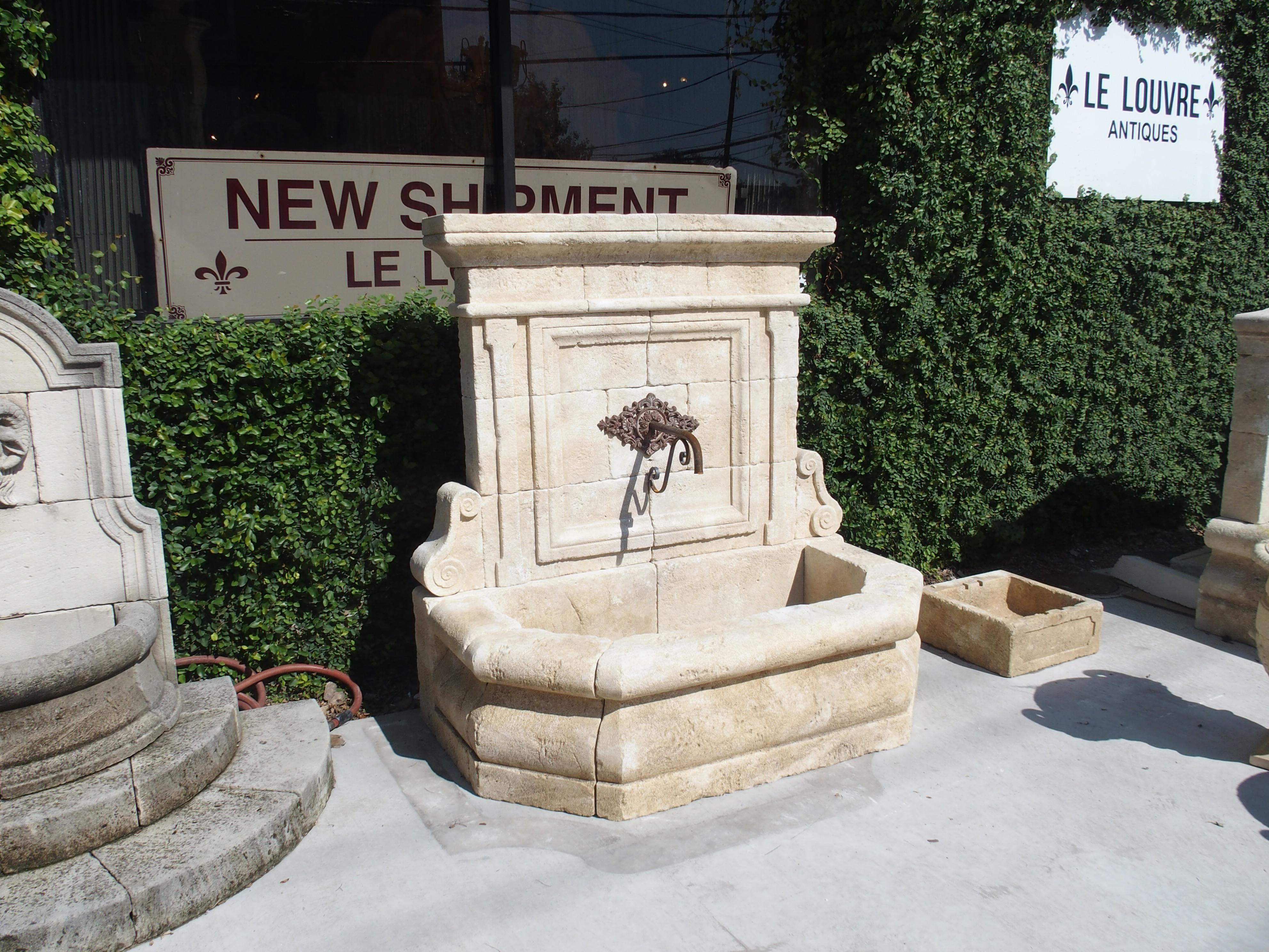 This wall fountain from The Vaucluse in Provence has been hand carved in Estaillade limestone. The elegantly carved stone fountain has a classical feel as there are a few iconic architectural features present. The crown features Cavetto molding,