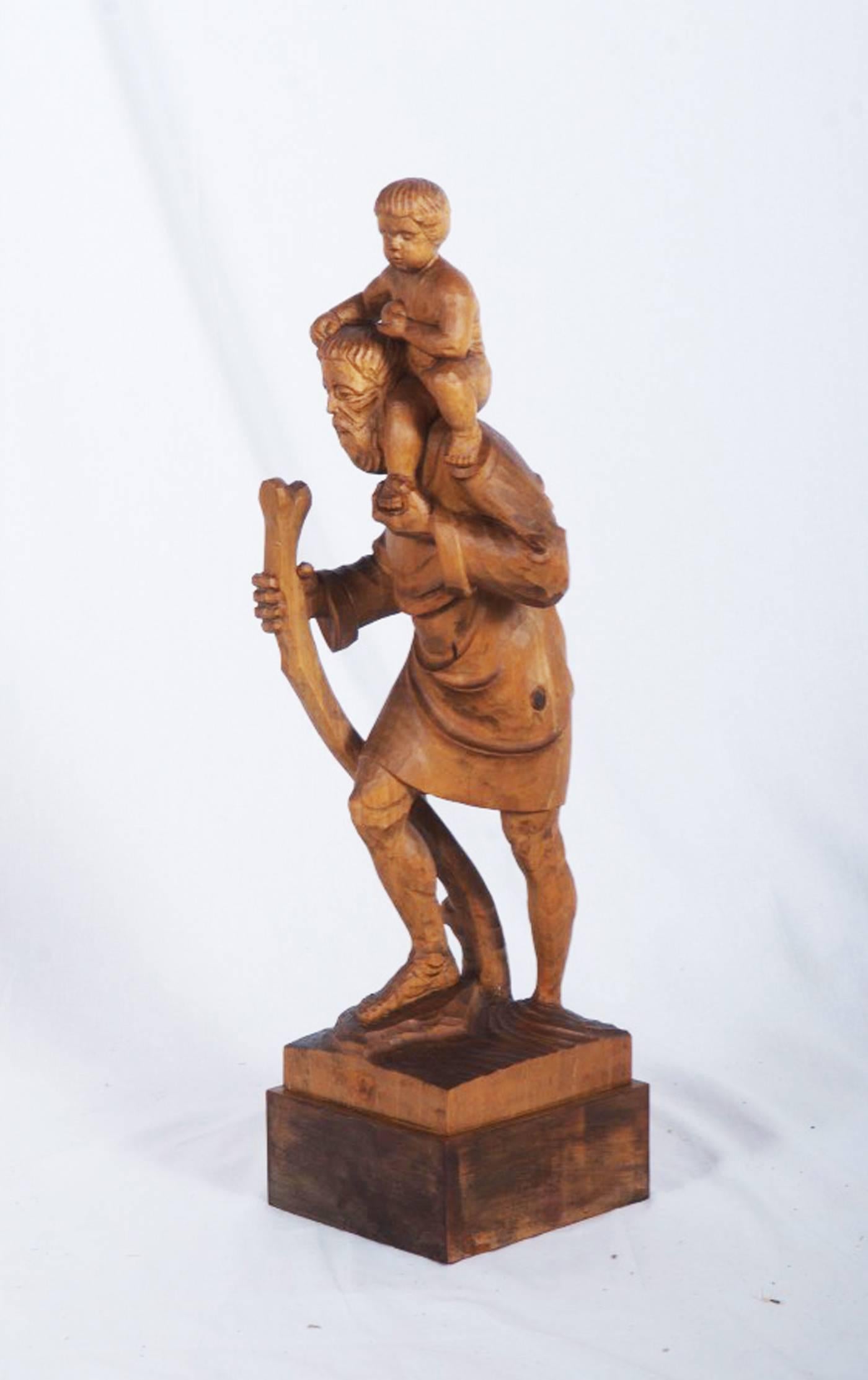 Limewood figure showing holy Christophorus with Jesus on the shoulder. Made in Hallein, Austria in the 1960s.