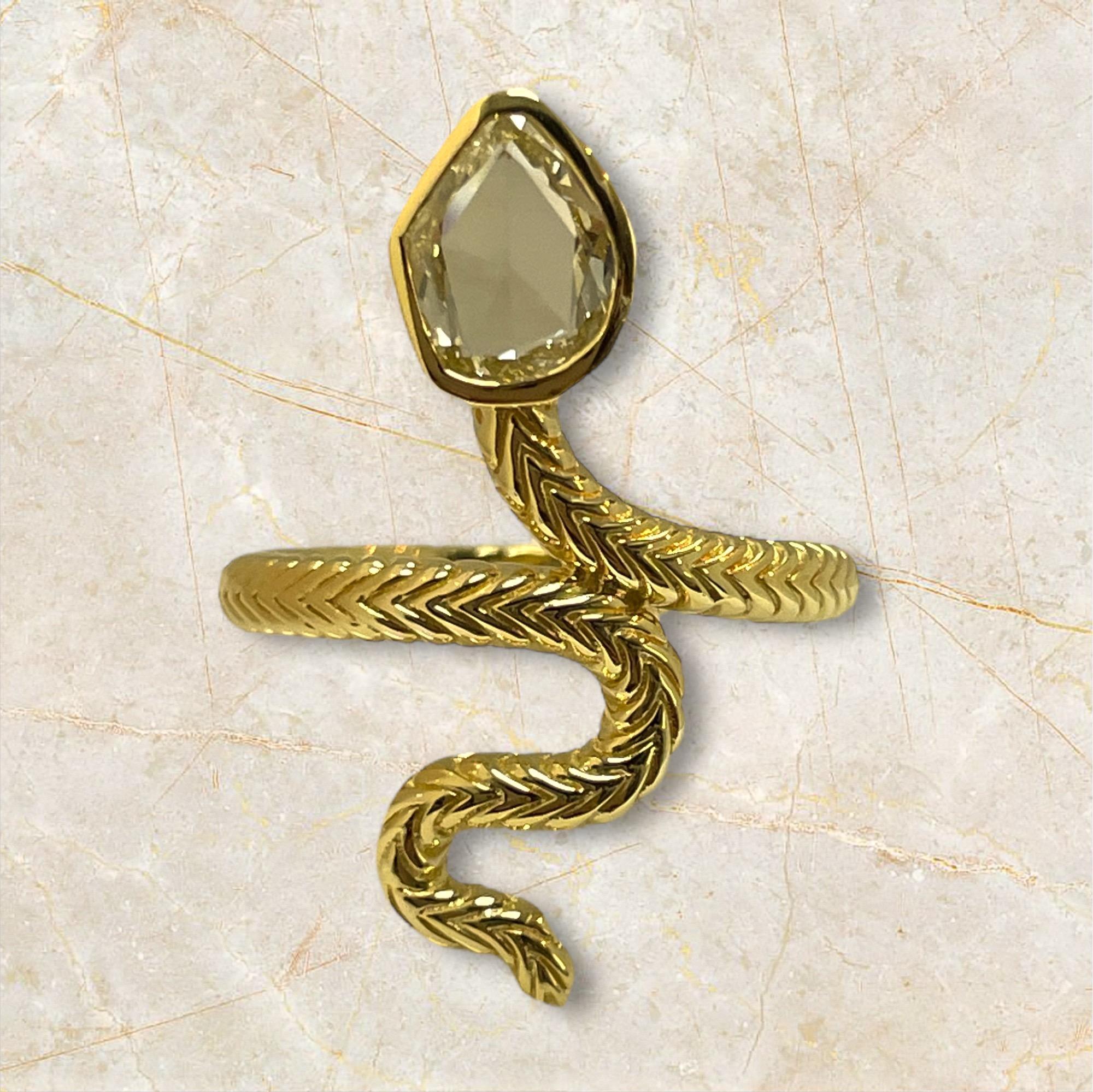 This limited edition 18K yellow gold snake ring showcases a stunning mix cut Natural diamond. The intricate design of the snake, combined with the unique diamond cut, creates a piece that exudes luxury and sophistication. Perfect for those seeking a