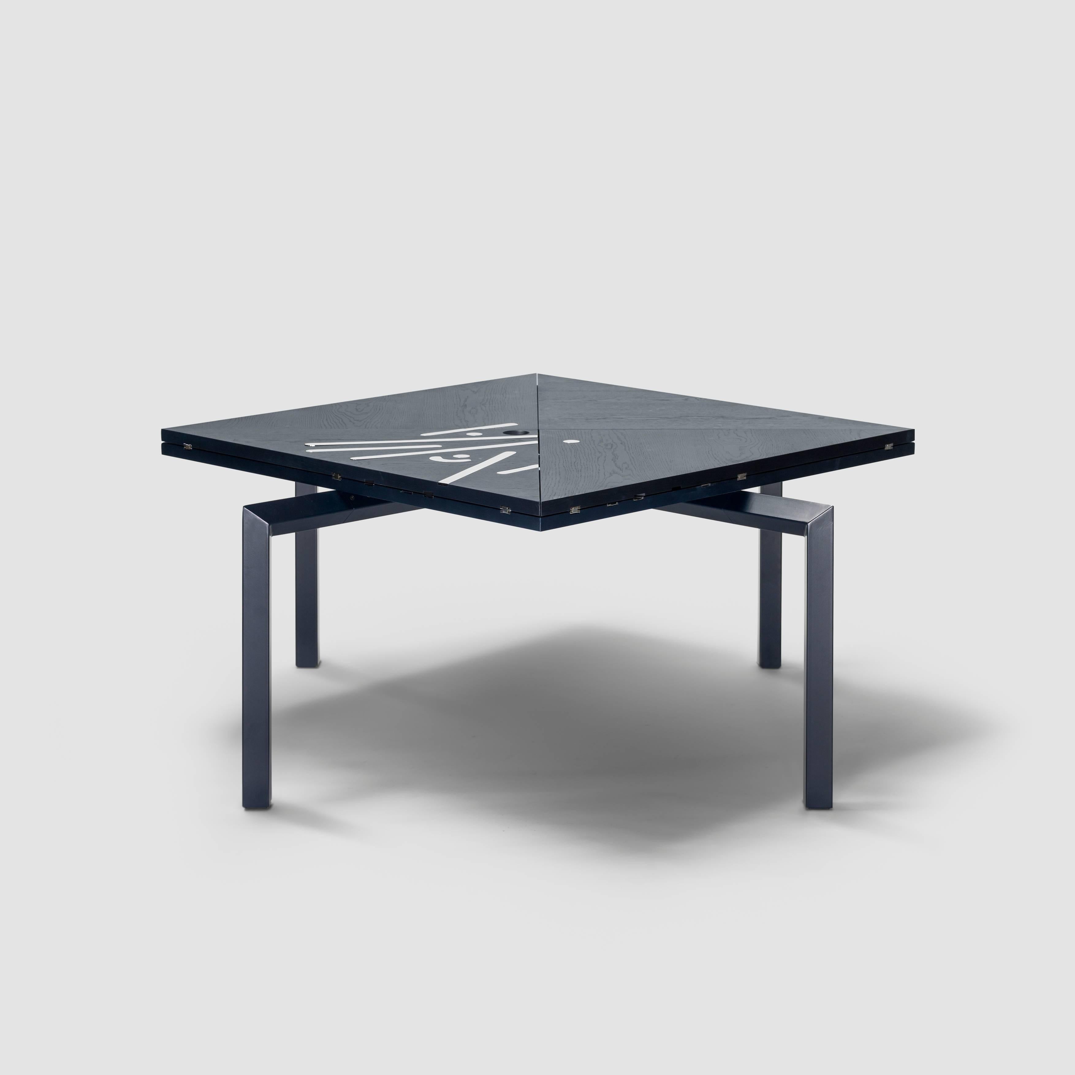 Alella table designed by Lluís Clotet.

Limited edition of 8 units + 2 artist proofs + 2 prototypes.
DM, oak veneered and stained in dark blue RAL 5004.
Legs in an iron rectangular tube lacquered in the same color as the top.
Decorative