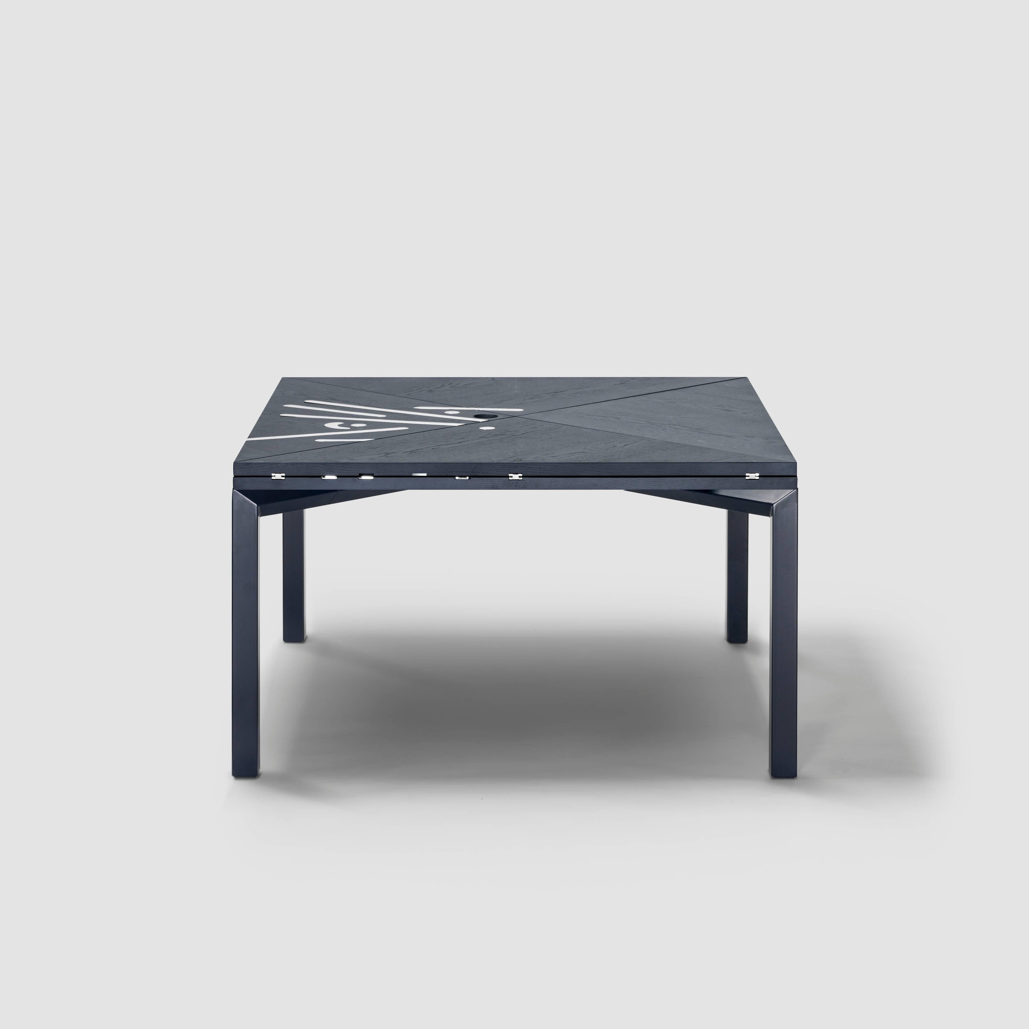 Alella table designed by Lluís Clotet.

Limited edition of 8 units + 2 artist proofs + 2 prototypes.
DM, oak veneered and stained in dark blue RAL 5004.
Legs in an iron rectangular tube lacquered in the same colour as the top.
Decorative chrome