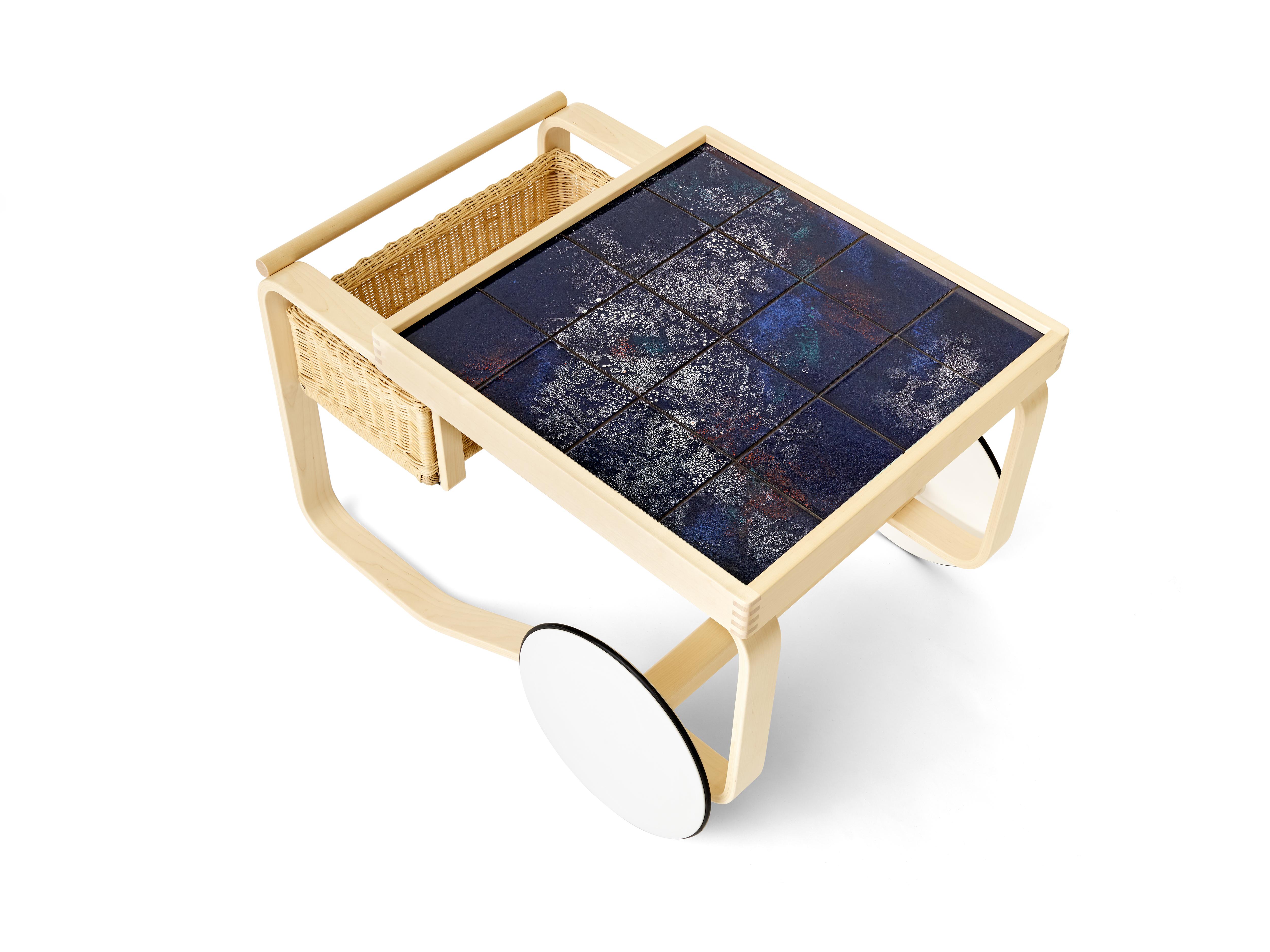 Experimental glazes from the 1940s meet innovative wood-bending techniques from the 1930s for a distinctive, memorable collection. As an edition of six designs with only six of each made, Artek's iconic Tea Trolley is inlaid with Heath tile in