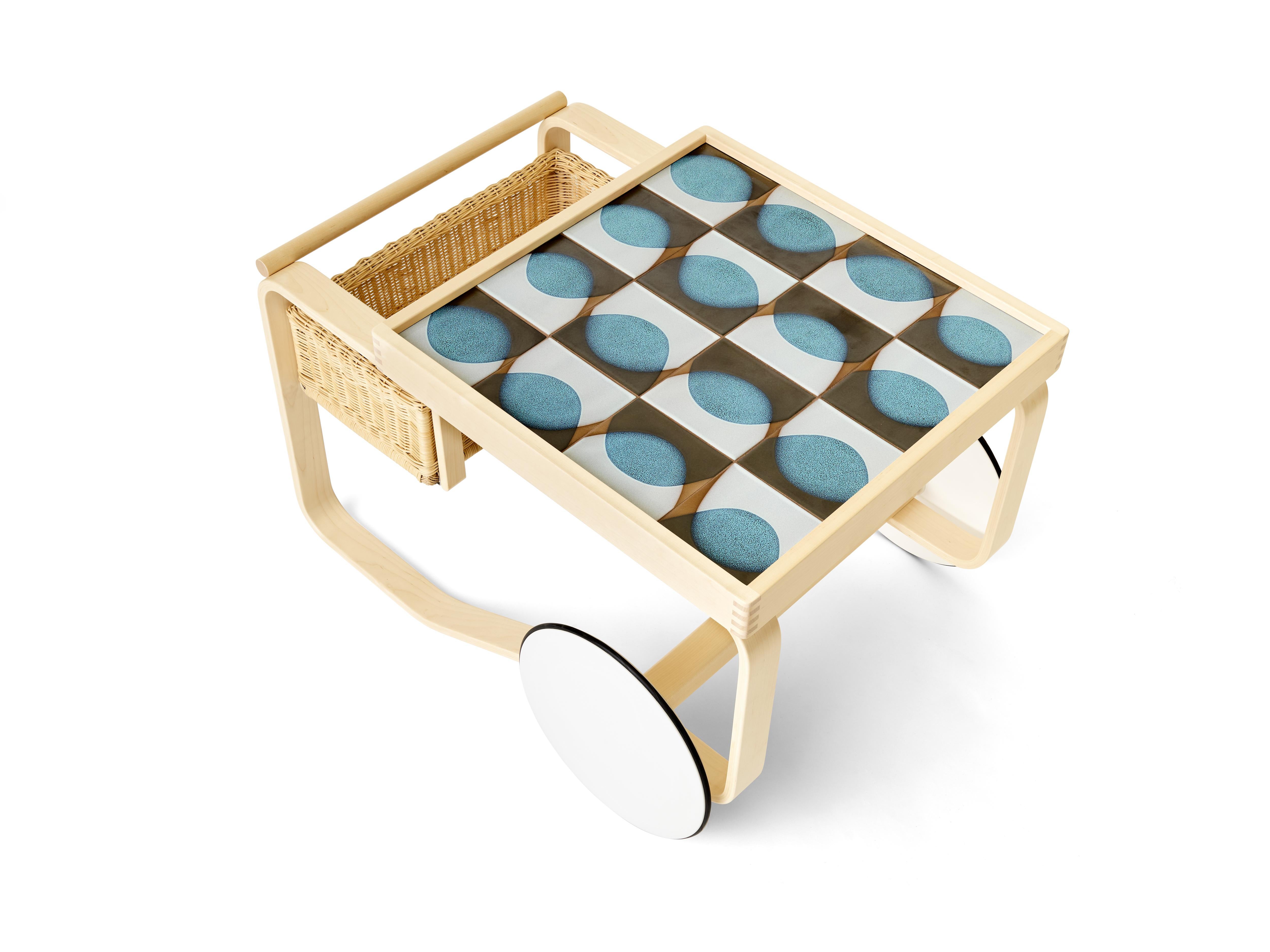 Experimental glazes from the 1940s meet innovative wood-bending techniques from the 1930s for a distinctive, memorable collection. As an edition of six designs with only six of each made, the iconic Artek tea trolley is inlaid with tile inspired by