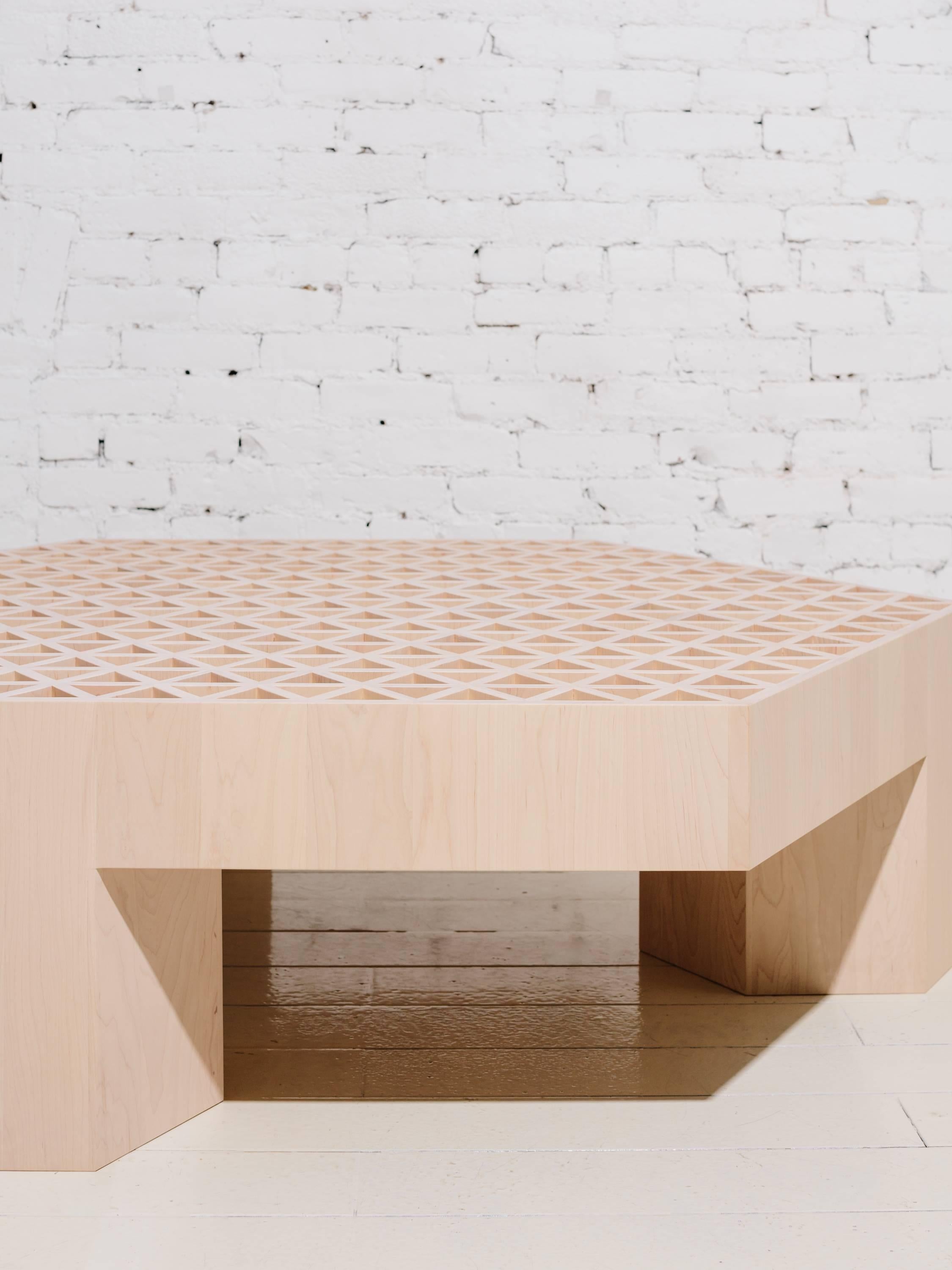 A part of Fort Standard’s “Qualities of Material” collection, the Assemblage coffee table is made from hundreds of thin, hard maple slats. The slats are assembled into the vertically oriented triangular tubes that make up the surface and extruded