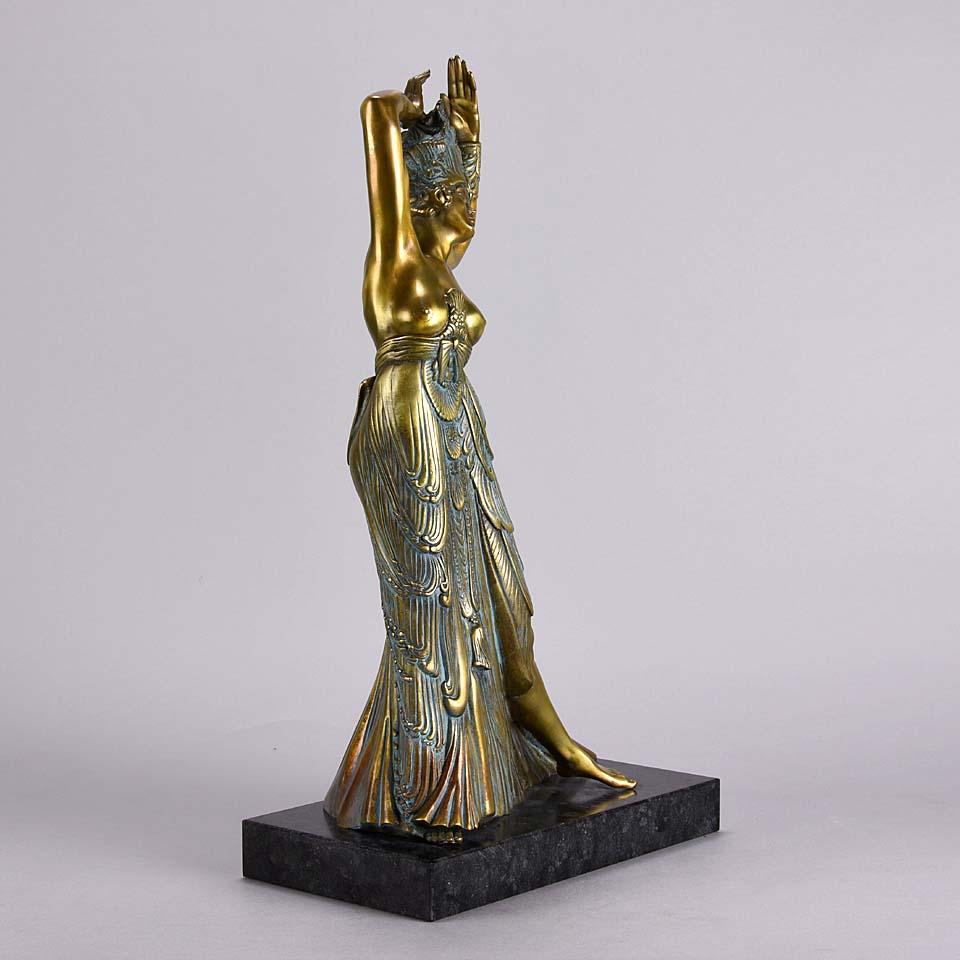 Enchanting gilt and enamel bronze study of the seductive young dancer wearing a revealing full length gown and a flamboyant head dress with her arms lifted above her head, raised on a marble base, signed and numbered 20/300.

Ernst Fuchs (13