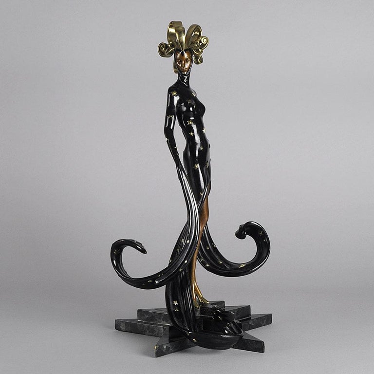 An exotic limited edition bronze figure of a beautiful young woman in flowing theatrical costume cold painted in deep black and highlighted with golden stars, the surface with good detail raised on an integral base, signed Erté, dated and