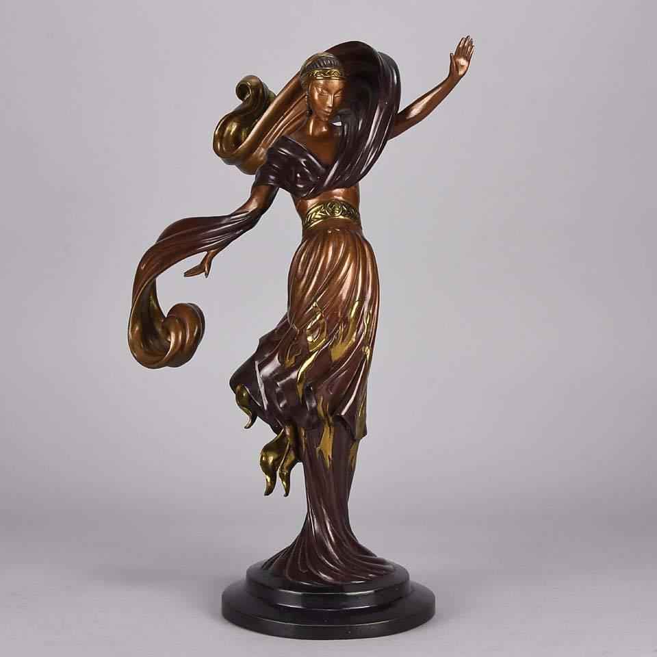 An eye-catching limited edition bronze figure of a beautiful young woman in flowing dress cold painted in variegated brown and highlighted with gilding with crisp surface detail raised on an integral base, signed Erté, dated and numbered.