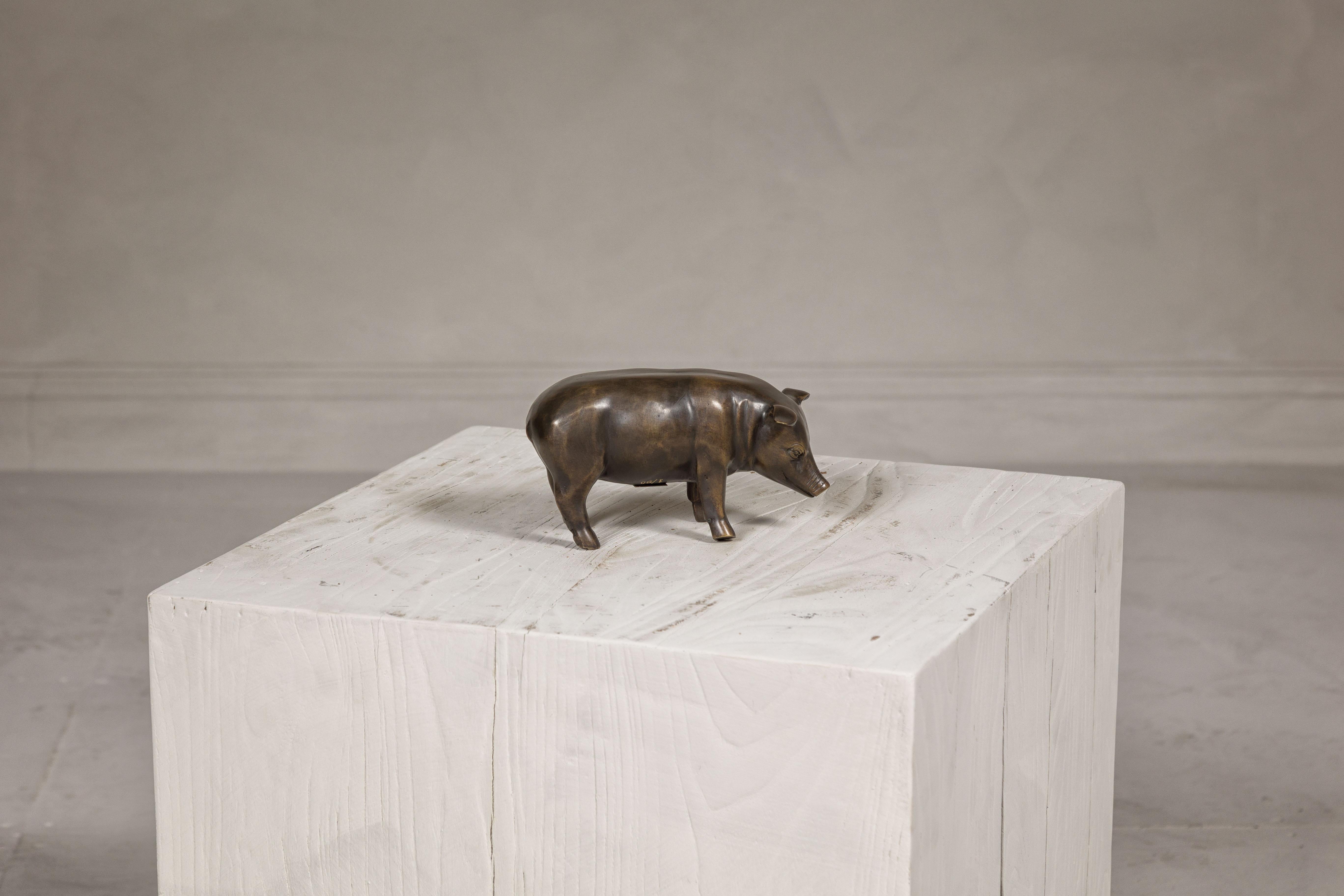 A limited edition cast bronze pig statuette from the Randolph Rose Collection. Crafted with meticulous detail, this limited edition cast bronze pig statuette is a charming piece from the Randolph Rose Collection. 

Number 1 out of a series of 50,