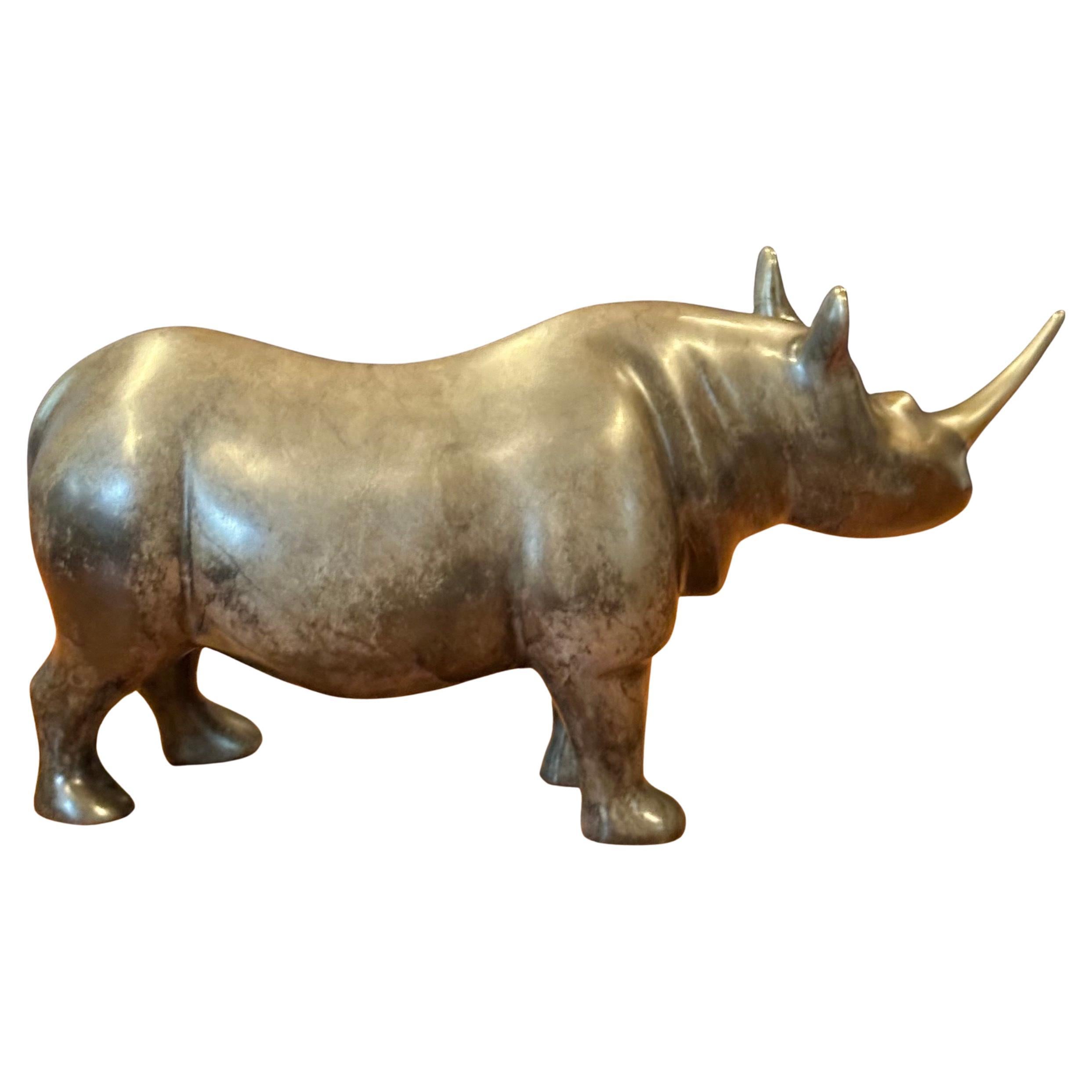 Limited edition bronze rhinoceros sculpture by Loet Vanderveen, circa 1990s. The piece is in very good vintage condition with a wonderful patina and measures 11.25