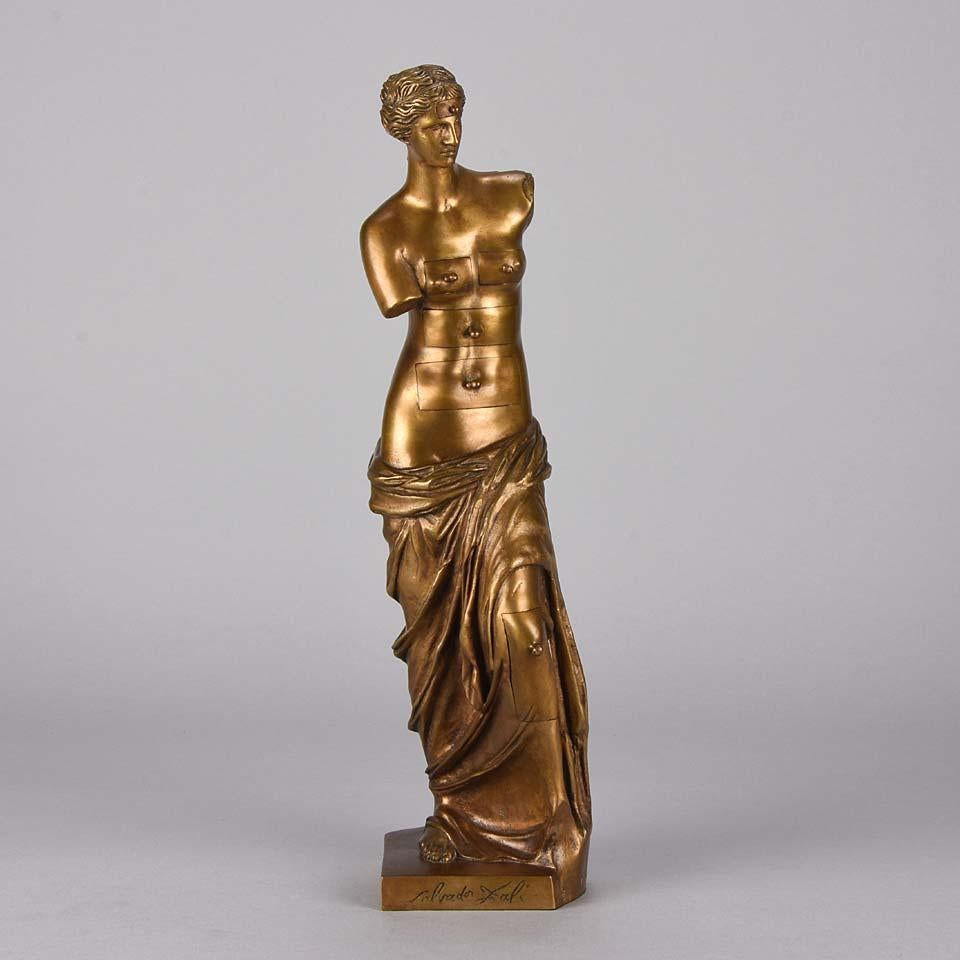 An excellent mid-20th century limited edition gilt bronze figure of Venus de Milo with Drawers by Salvador Dali – The figure of Venus de Milo incorporating drawer compartments to her head, breasts, torso and left leg to symbolize the memory and the