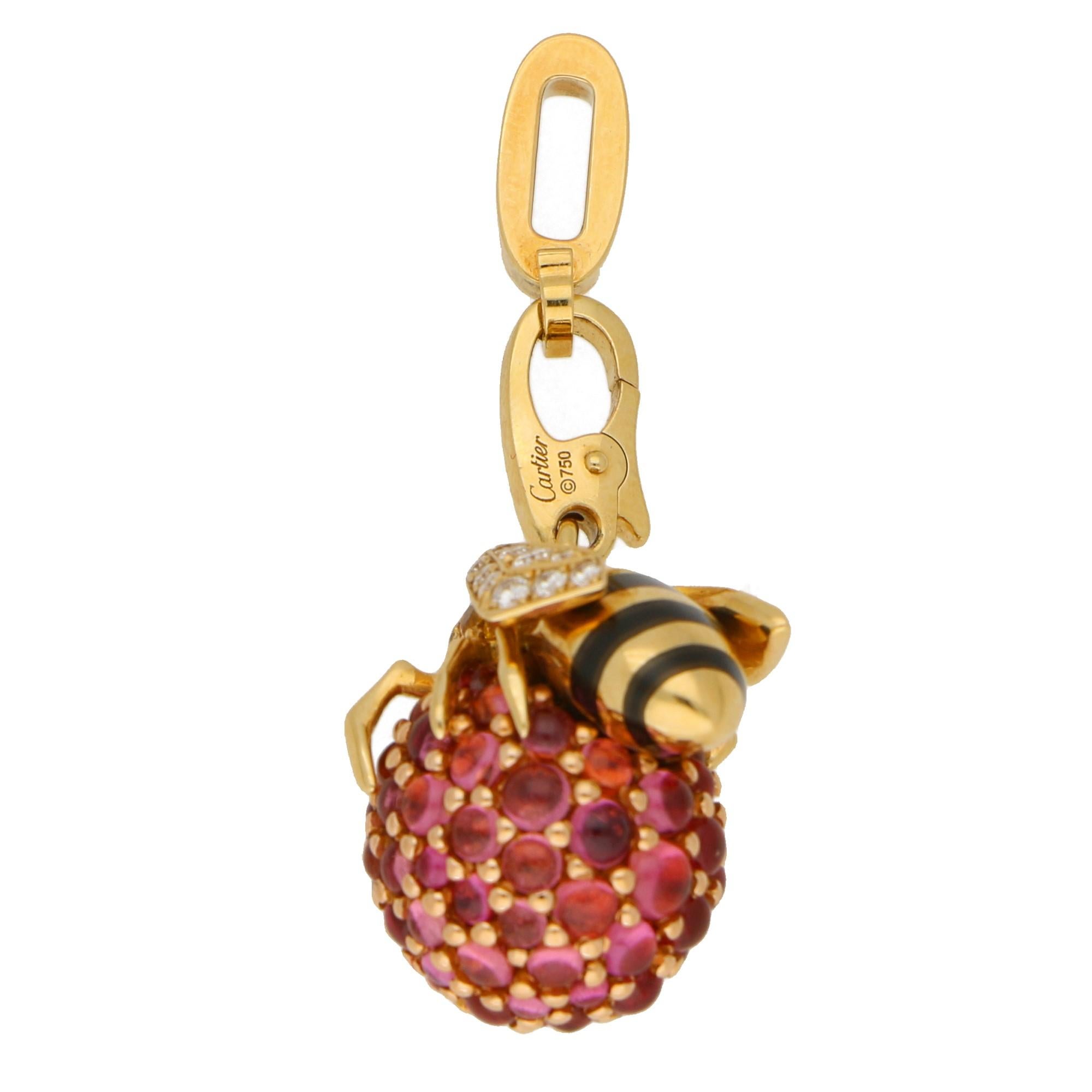 A limited edition Cartier Bee charm in 18-karat yellow gold. This charm, limited to 24 pieces worldwide, portrays a bee laying on a raspberry. The bee is designed in polished yellow gold, with black lacquer stripes on the tail, rubover-set