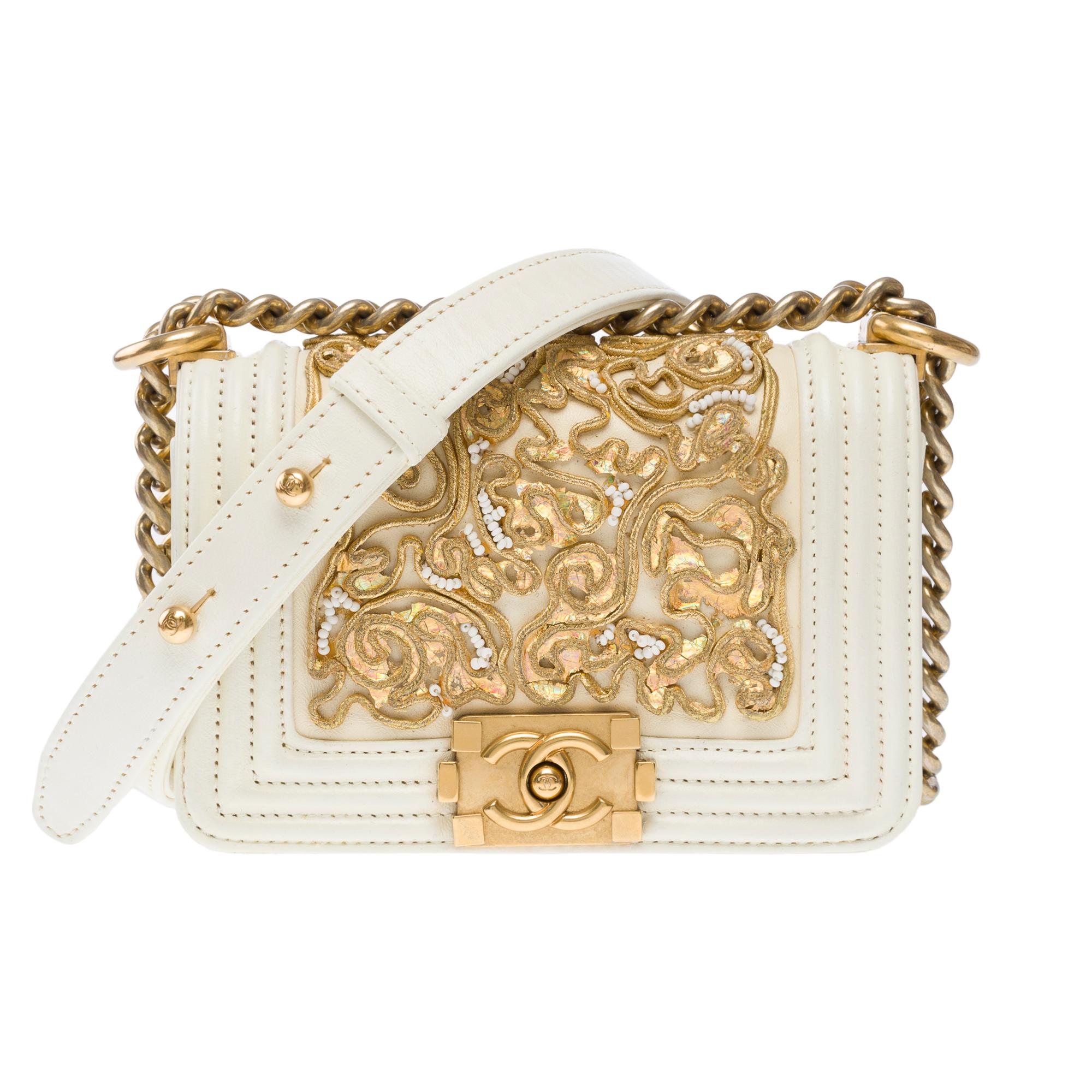 Splendid​ ​&​ ​Rare​ ​Chanel​ ​Mini​ ​Boy​ ​limited​ ​edition​ ​Versailles​ ​Cruise​ ​Collection​ ​shoulder​ ​bag​ ​in​ ​ecru​ ​leather​ ​embellished​ ​with​ ​golden​ ​embroidery​ ​and​ ​white​ ​beads,​ ​matte​ ​gold​ ​metal​ ​trim,​ ​an​