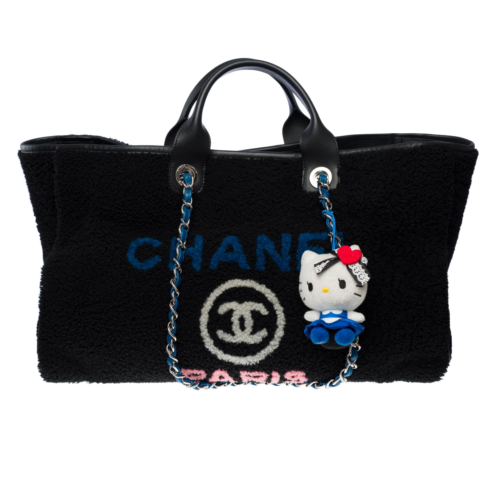 Stunning​ ​Chanel​ ​Deauville​ ​GM​ ​Limited​ ​Edition​ ​Tote​ ​Bag​ ​in​ ​black​ ​lambswool​ ​and​ ​leather,​ ​with​ ​silver-tone​ ​metal​ ​hardware.​ ​It​ ​features​ ​double​ ​silver-tone​ ​chain​ ​handles​ ​interlaced​ ​with​ ​light​ ​blue​