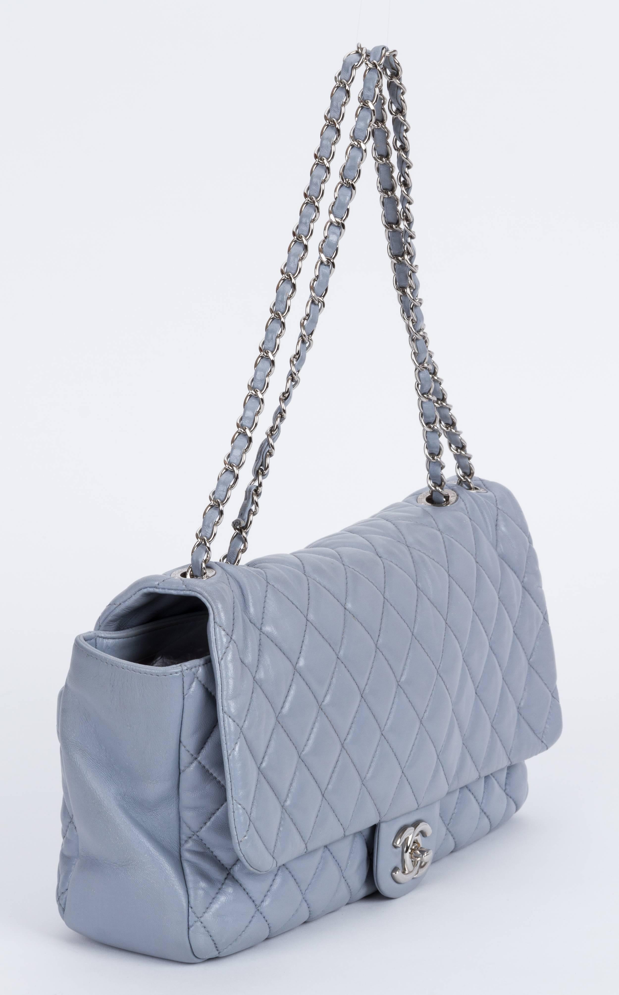 Chanel limited edition grey lambskin quilted maxi flap with silver tone hardware. Special edition with retractable rain jacket. Measurements: 13