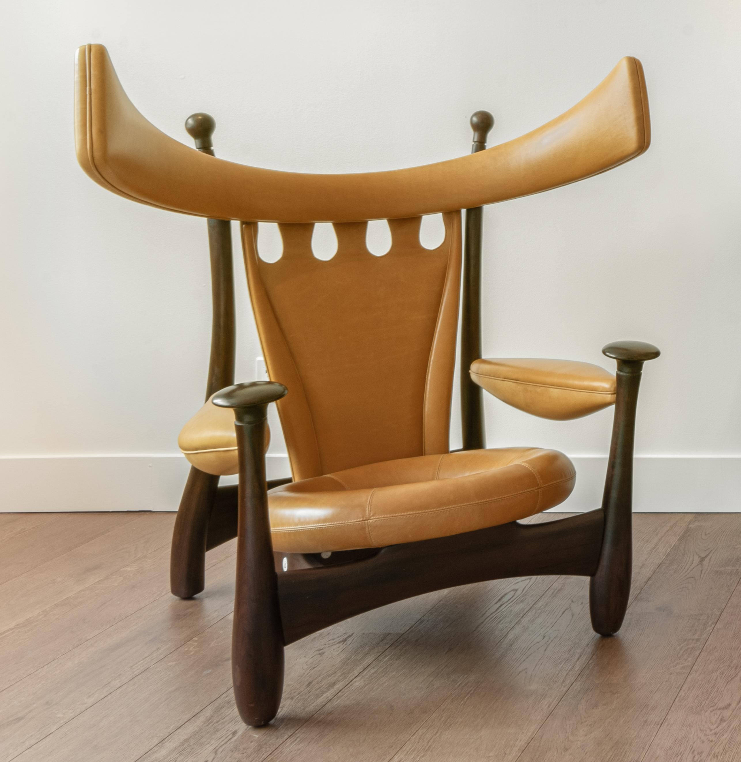 Originally upholstered in red leather, this chair is from an edition of 40 sold exclusively by Espasso NYC. The chair has been reupholstered in a soft cognac-colored leather. The frame is Imbuia wood. The chair is edition 12 of 40.

Initially