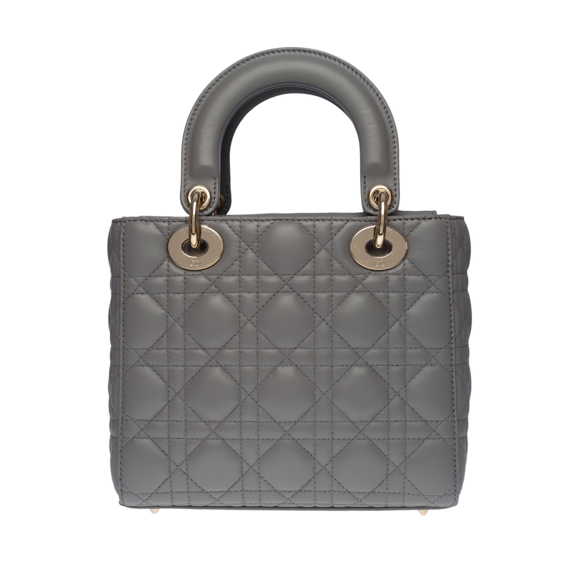 The Lady Dior small model bag perfectly embodies the vision of elegance and beauty of the house of Dior. Refined and feminine, this creation is timeless. Crafted in grey pearl lambskin with Cannage stitching, it has a legendary quilted texture that